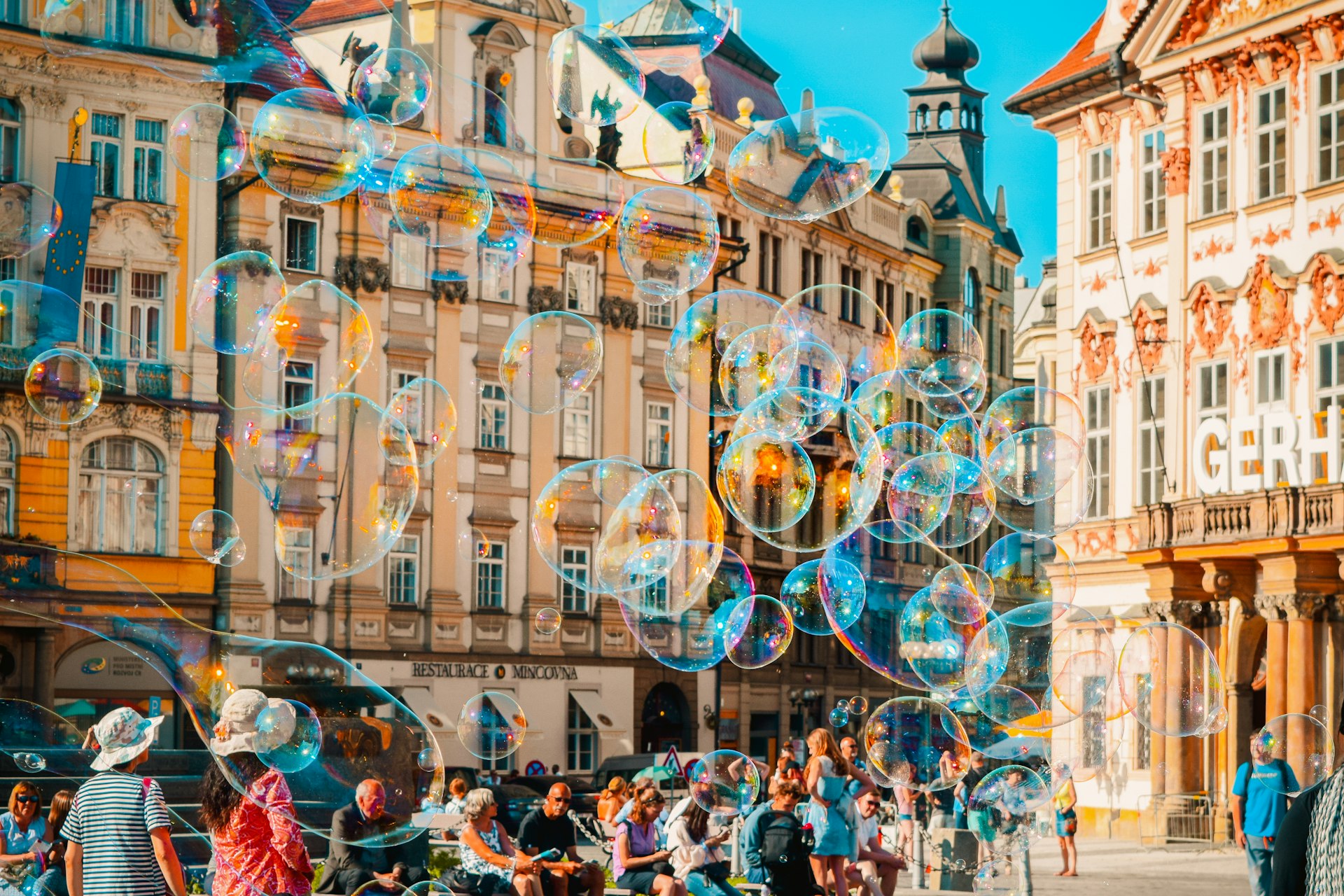 a group of people standing on a street next to tall buildings