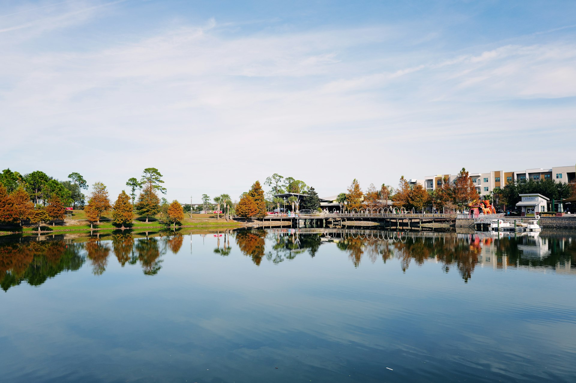A body of water surrounded by trees and buildings