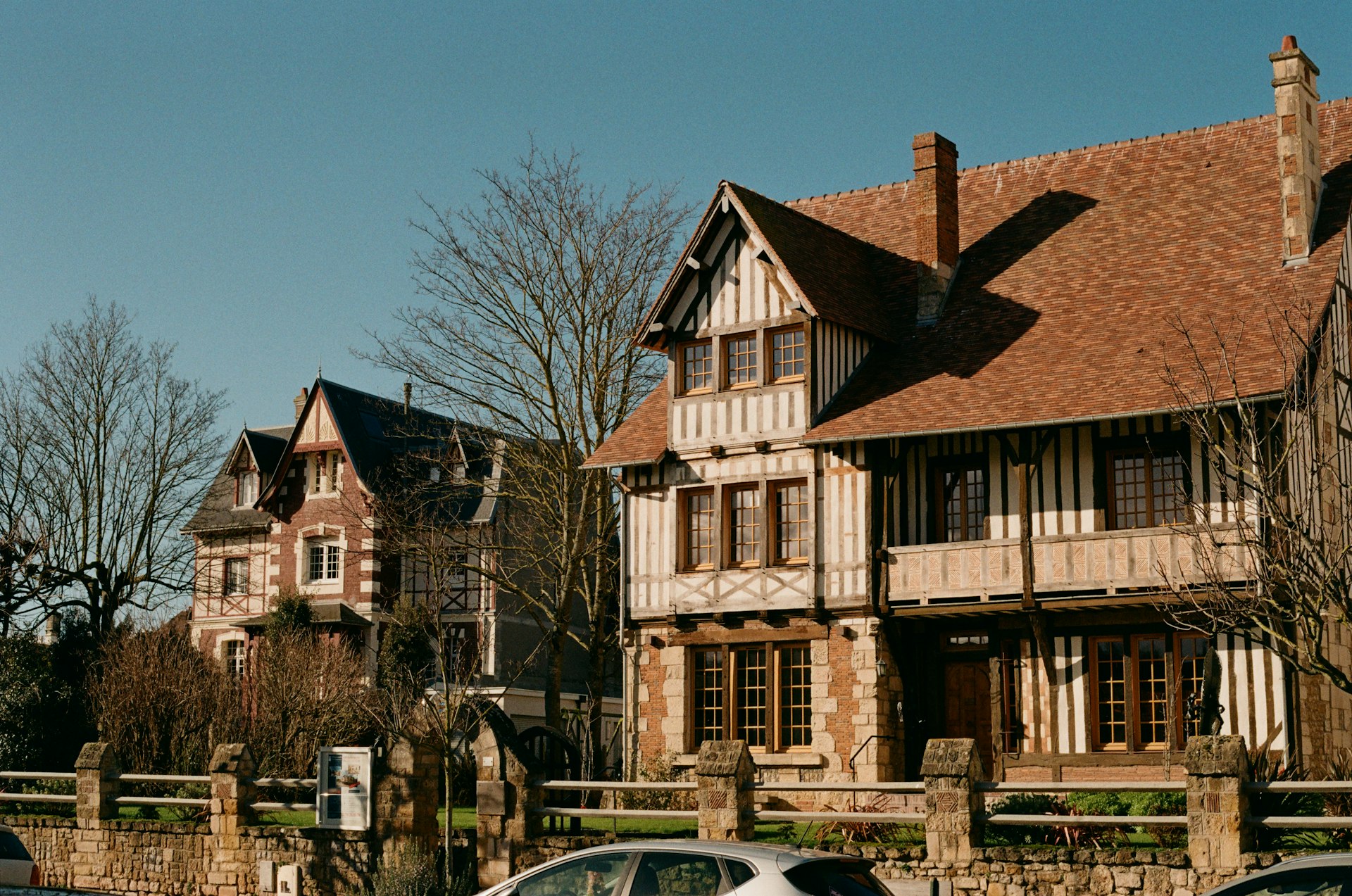A row of parked cars in front of a house