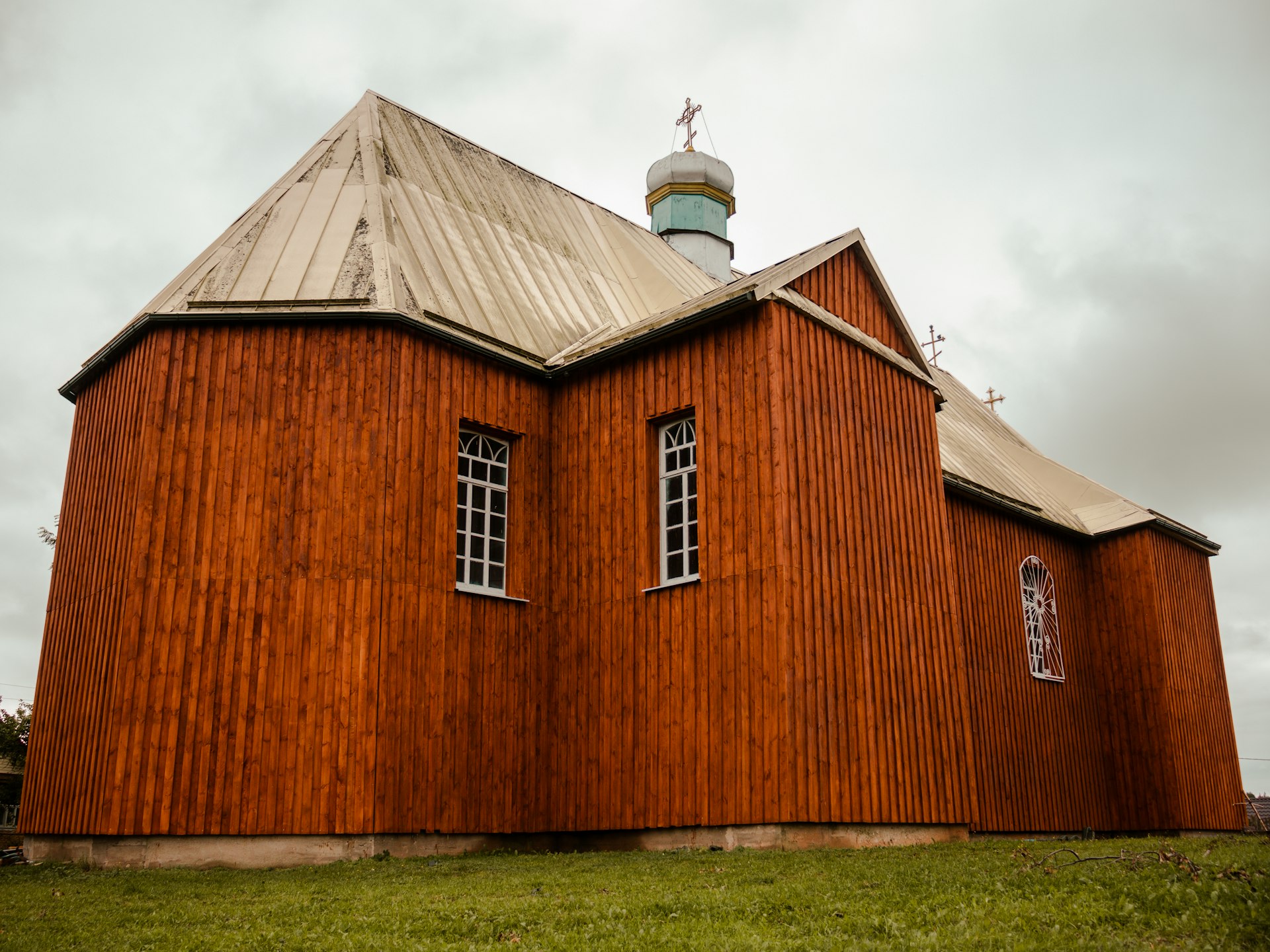 a red building with a steeple and two windows