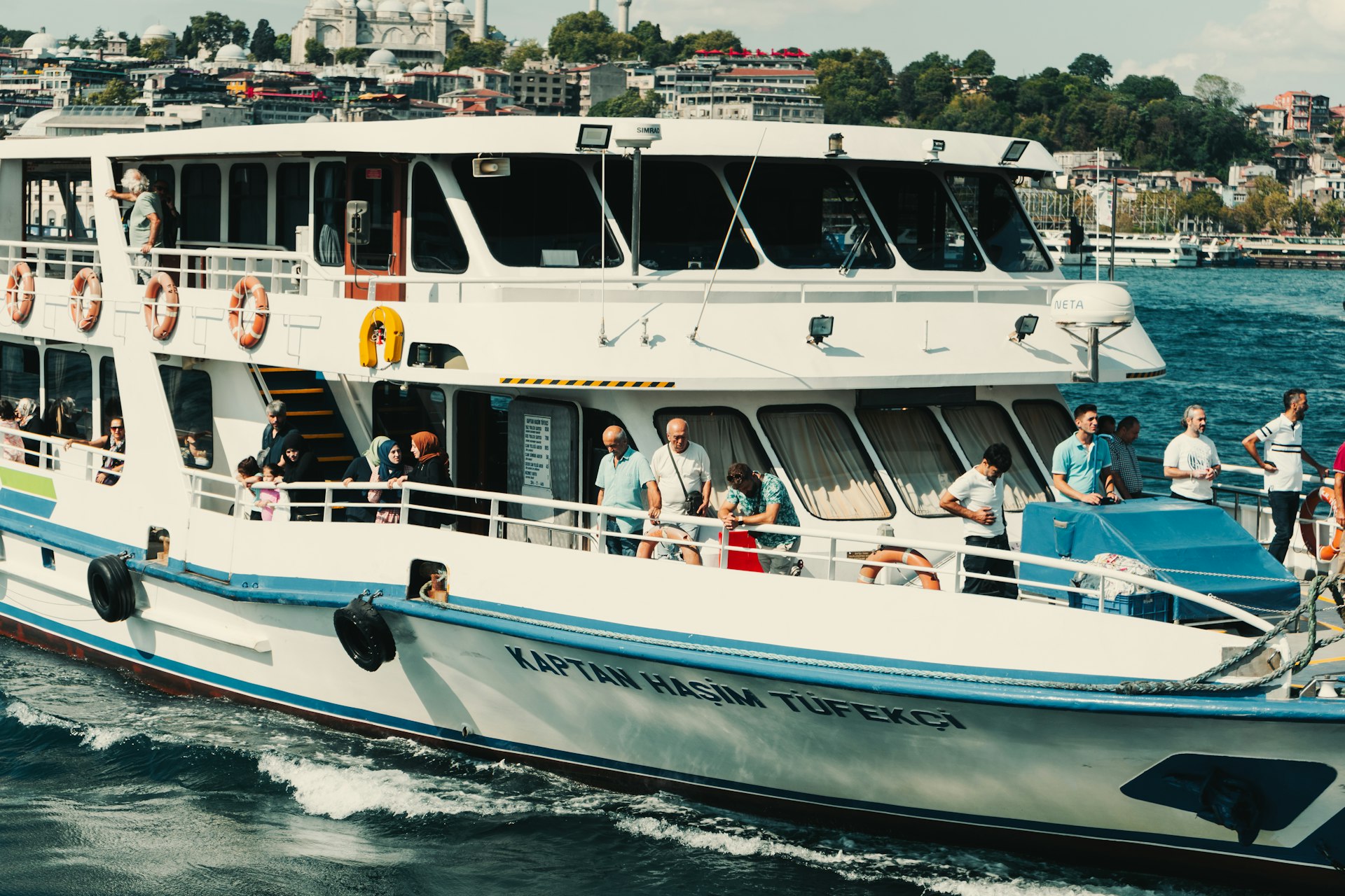 a large white and blue boat with people on it