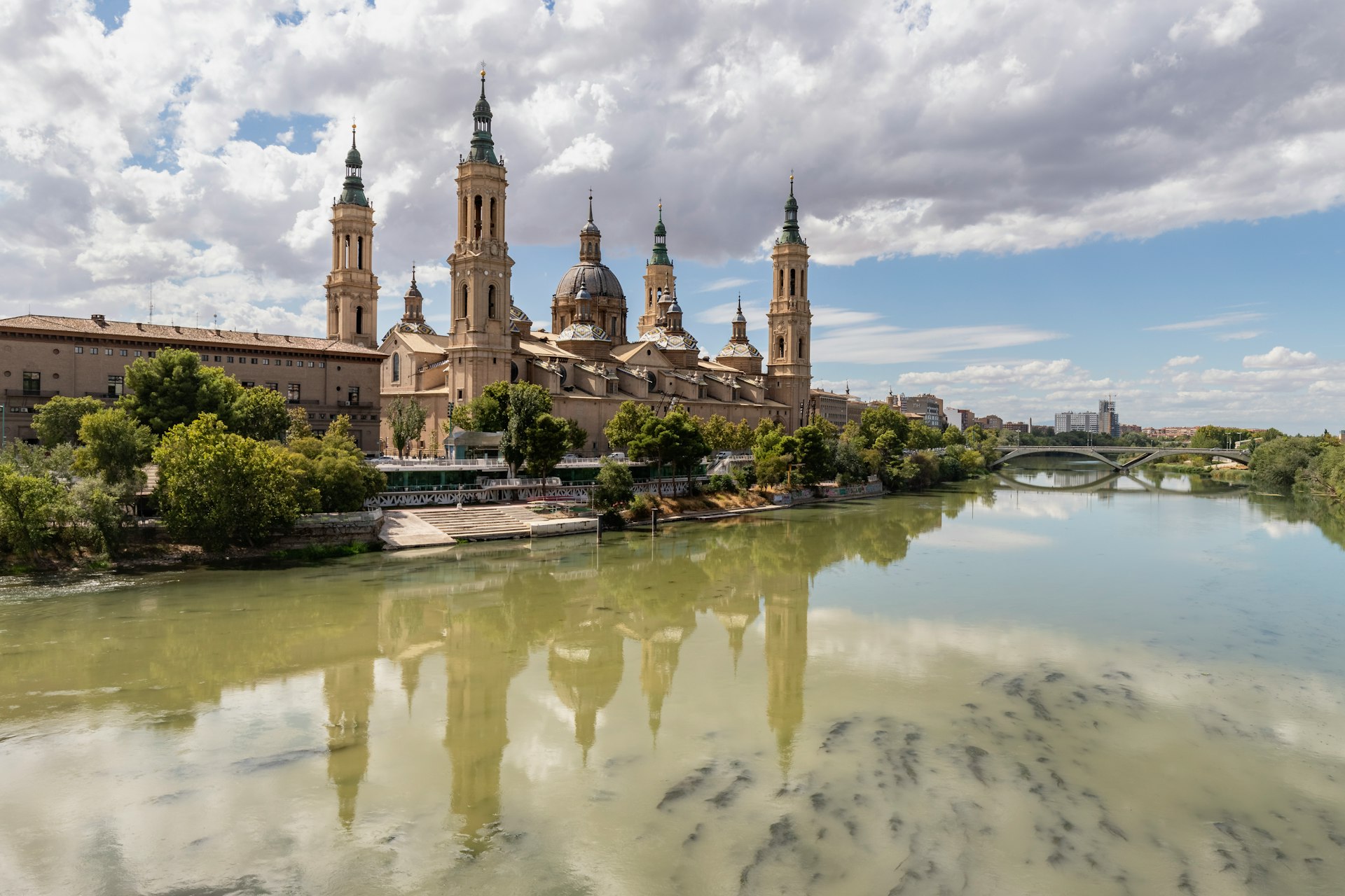 a large building with towers and a bridge over a body of water