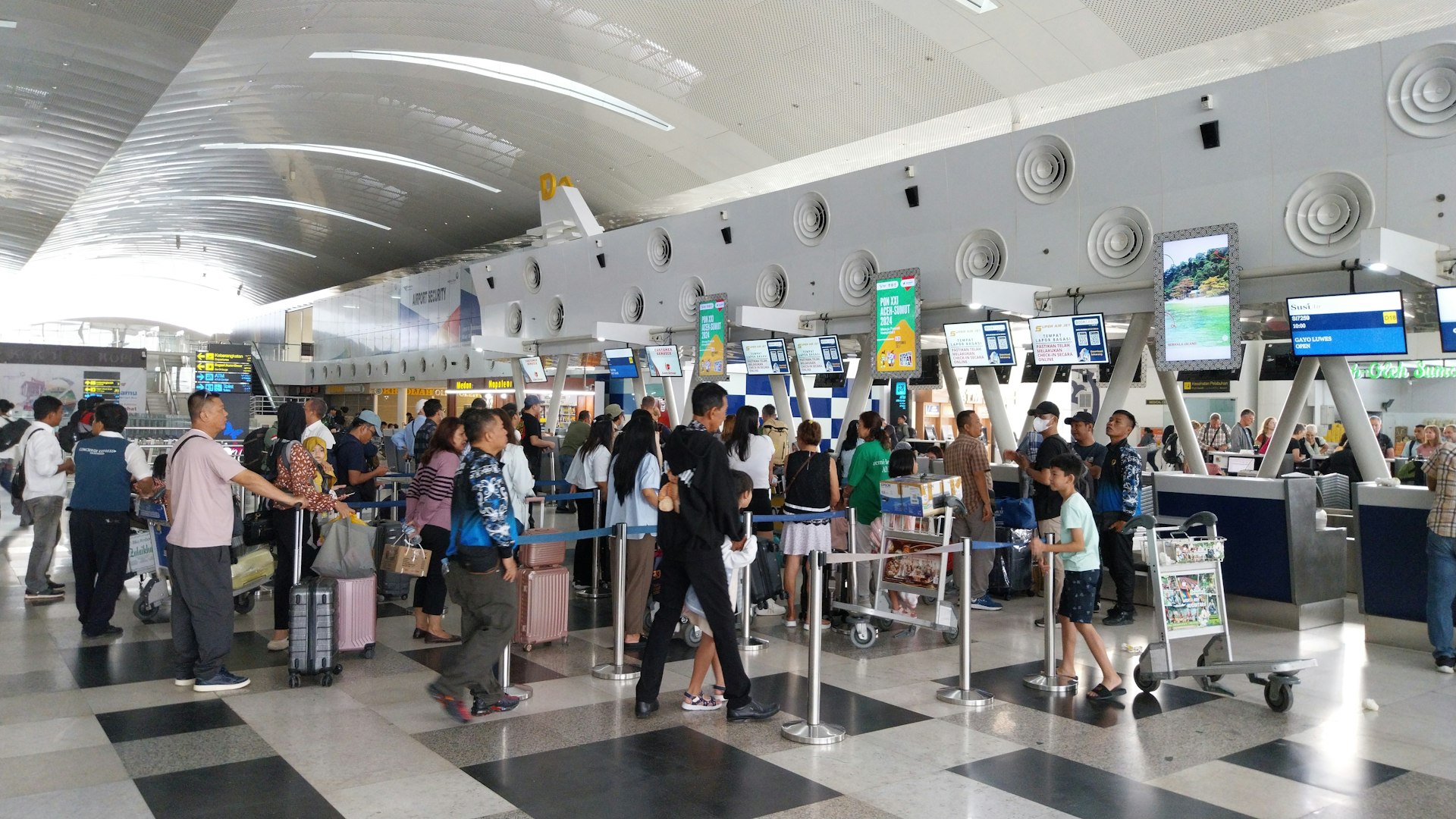A large group of people waiting in line at an airport
