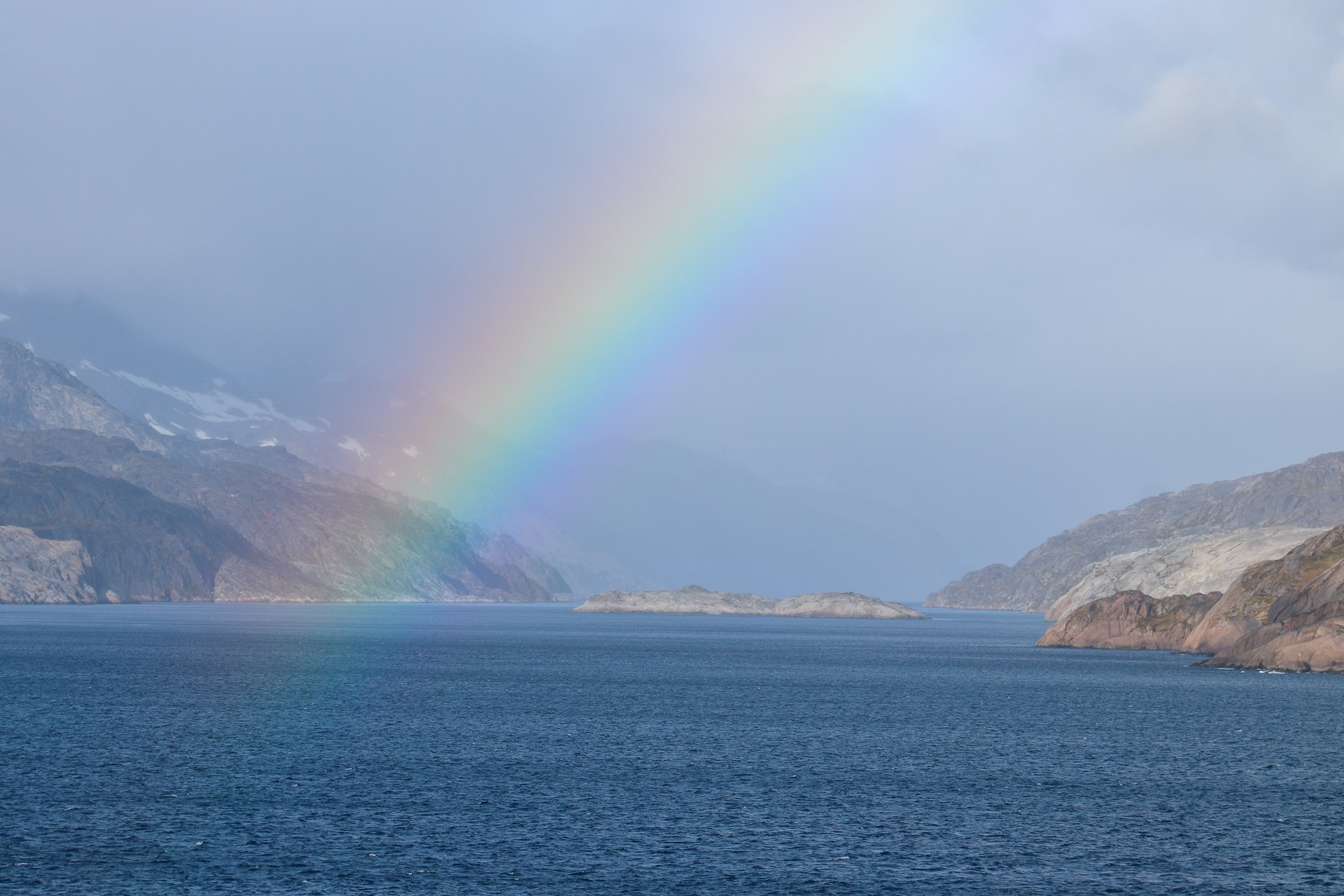 a rainbow in the sky over a body of water