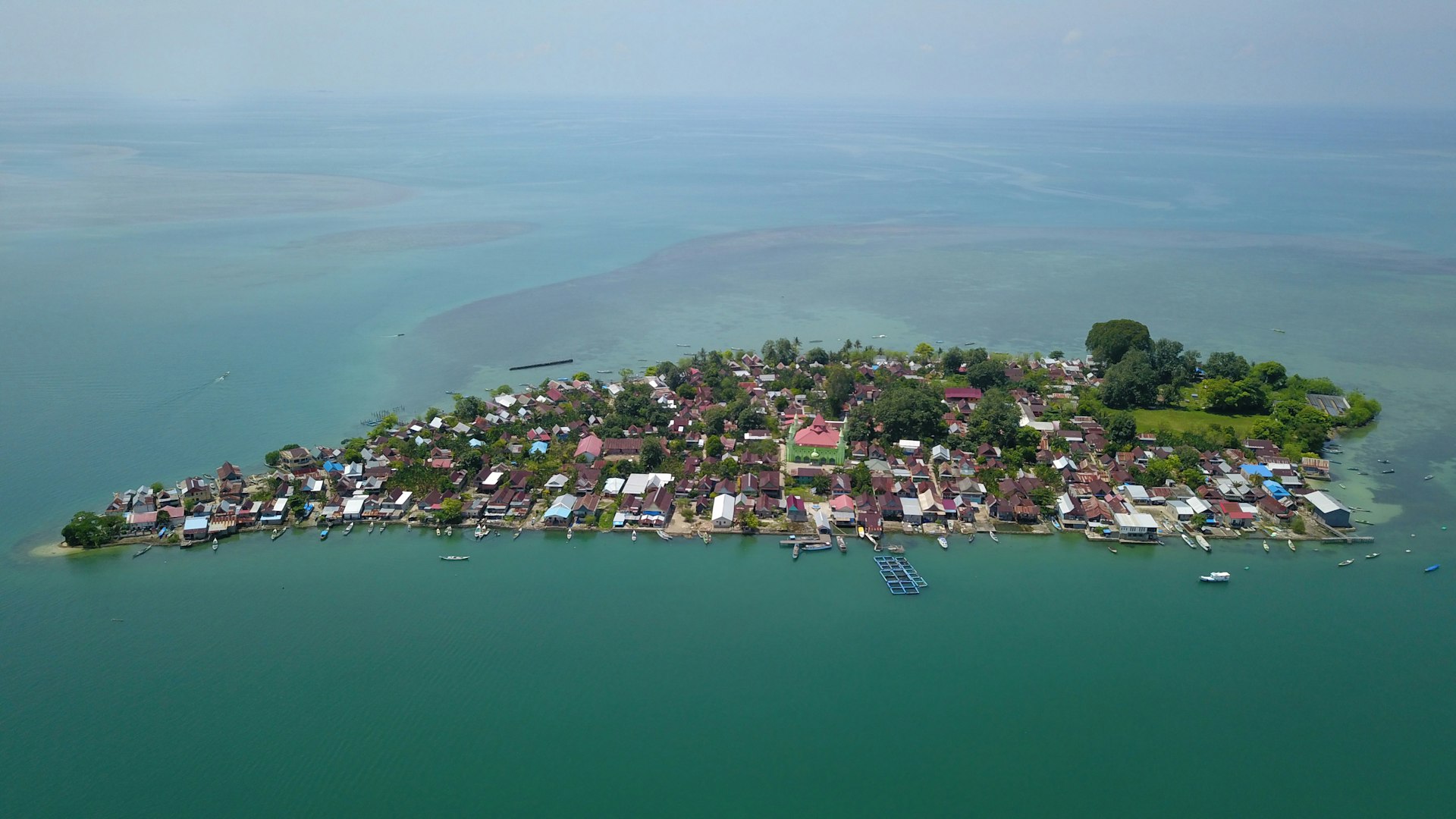 an aerial view of a small island in the middle of the ocean