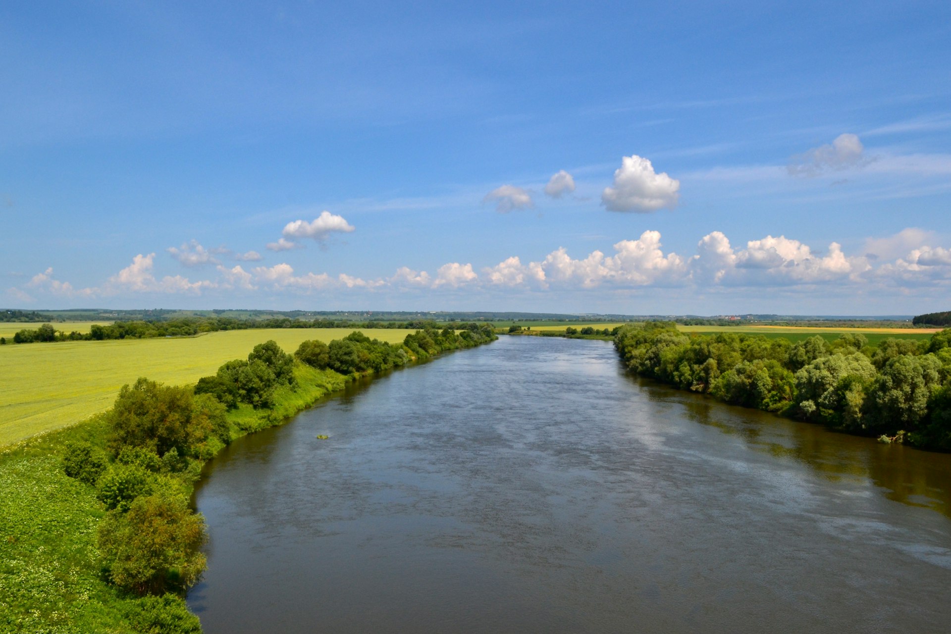 a river running through a lush green countryside