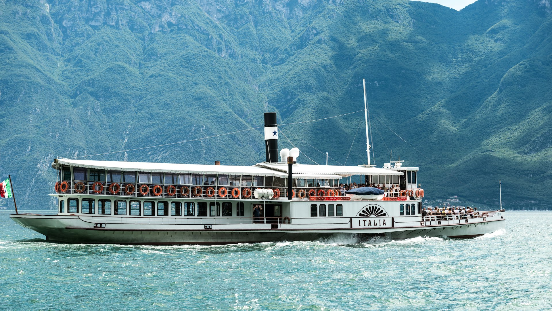 A large white boat floating on top of a body of water