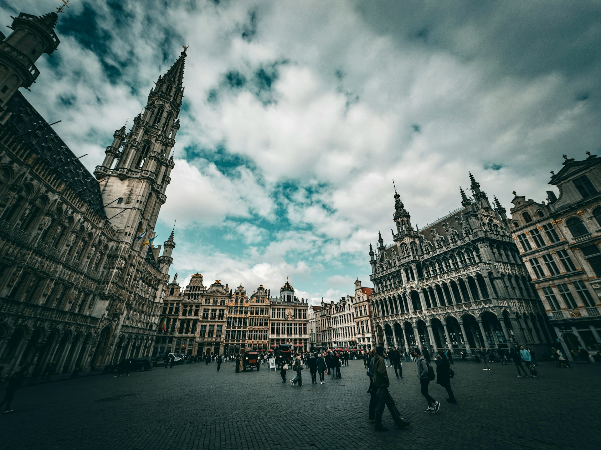 Grand place in brussels with cloudy skies.