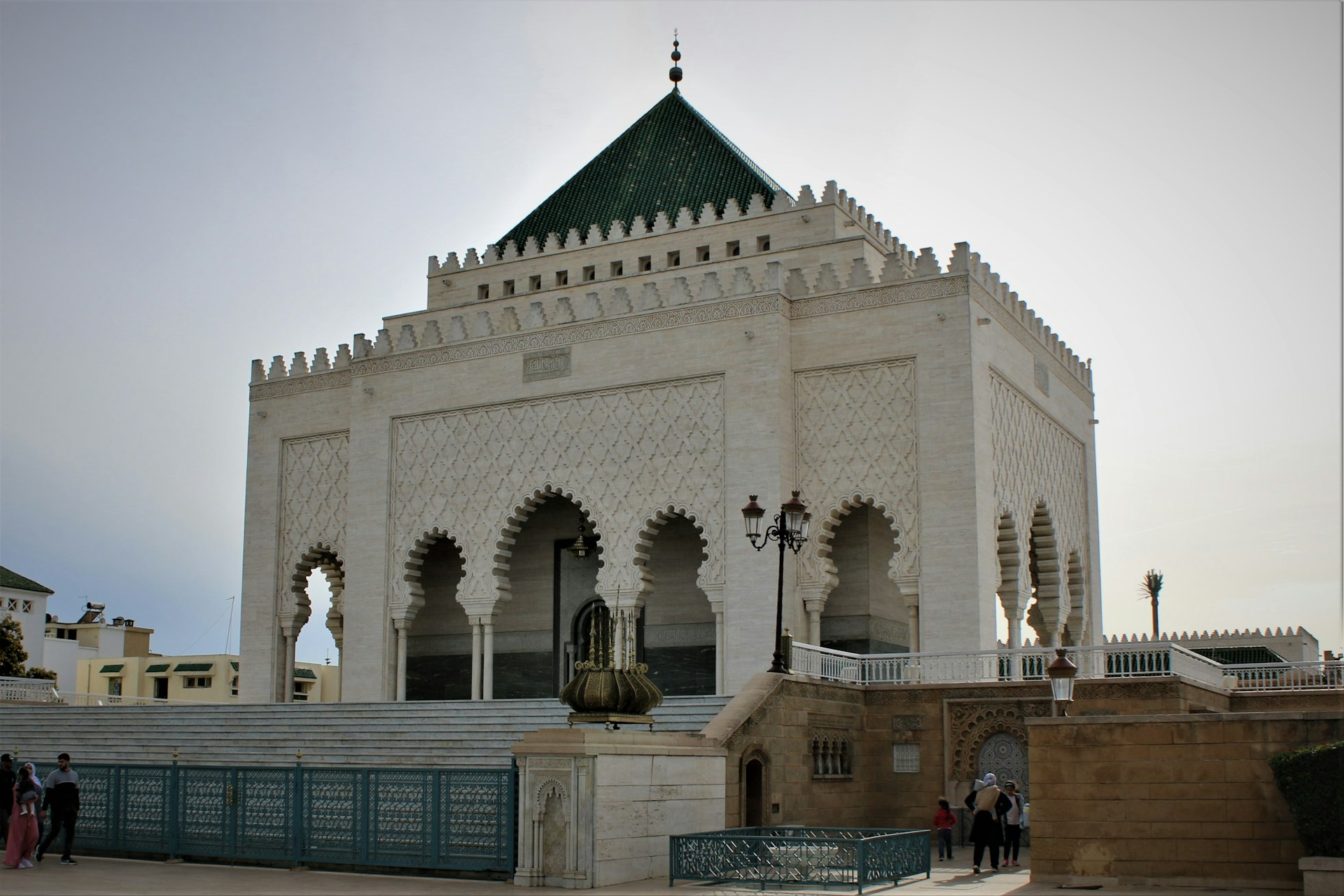 a large white building with a green roof