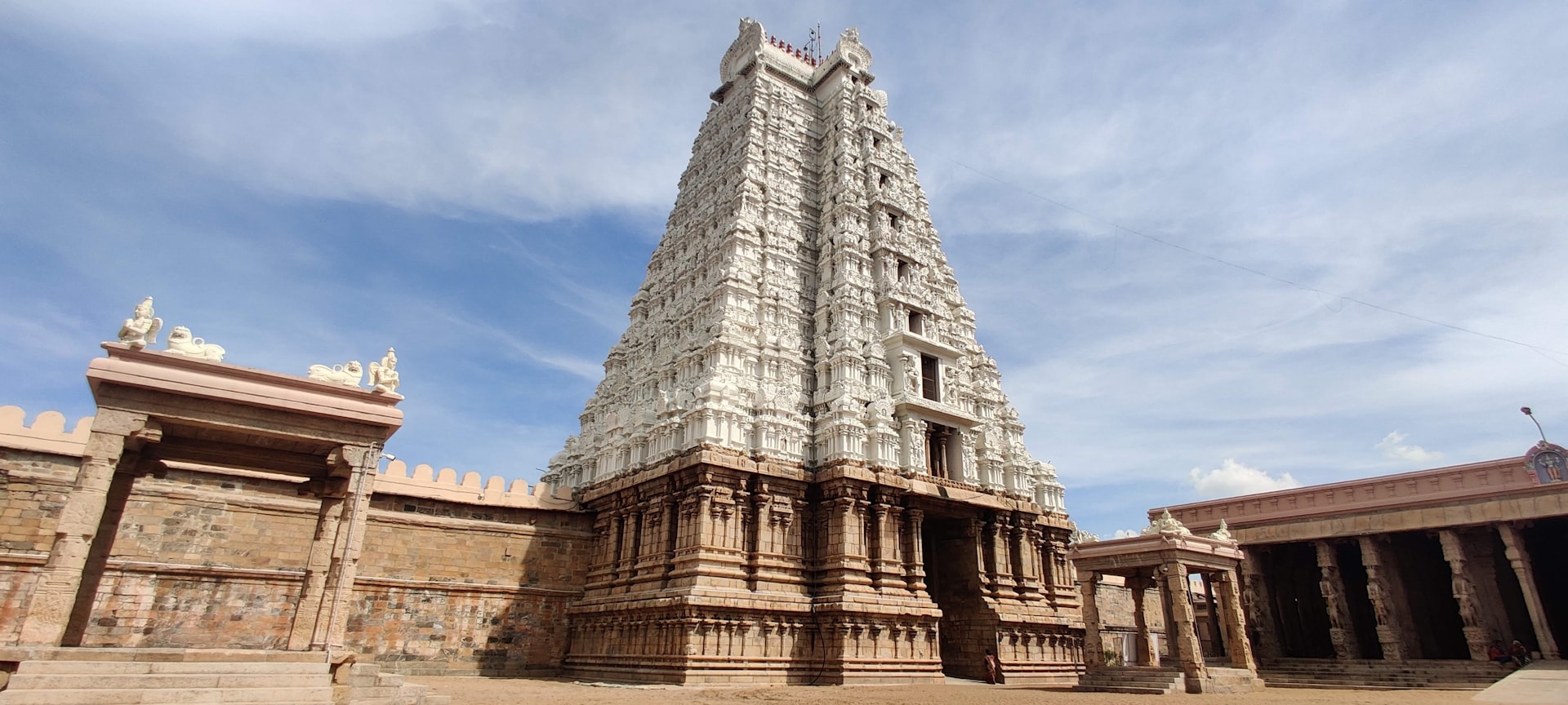 a very tall white building with a clock on it's side