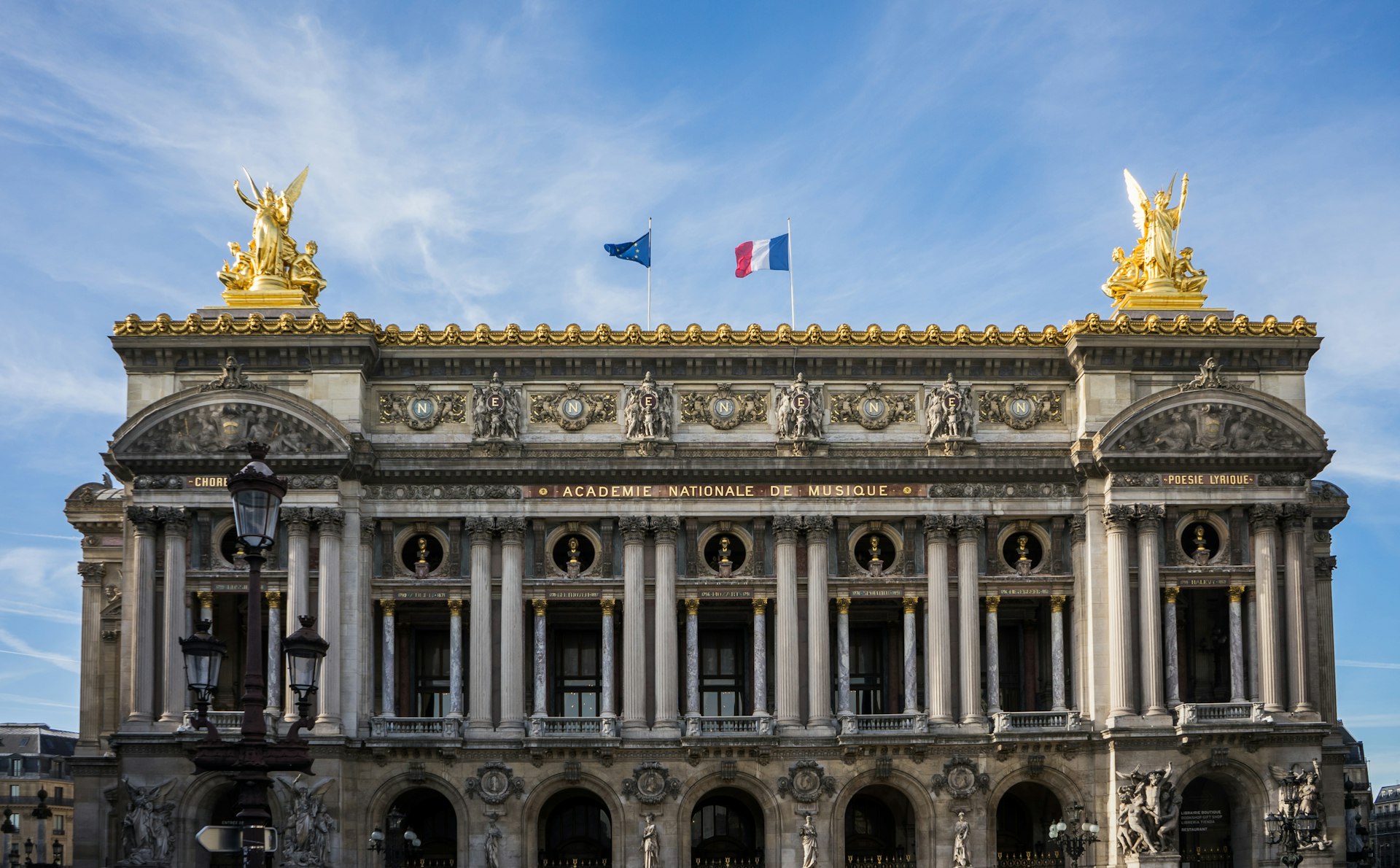 a large building with two flags on top of it