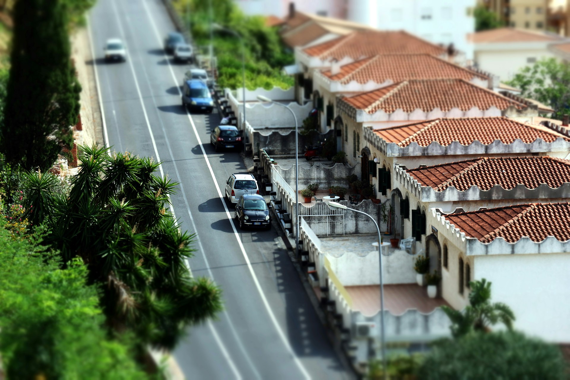 A view of a street with cars parked on the side of it