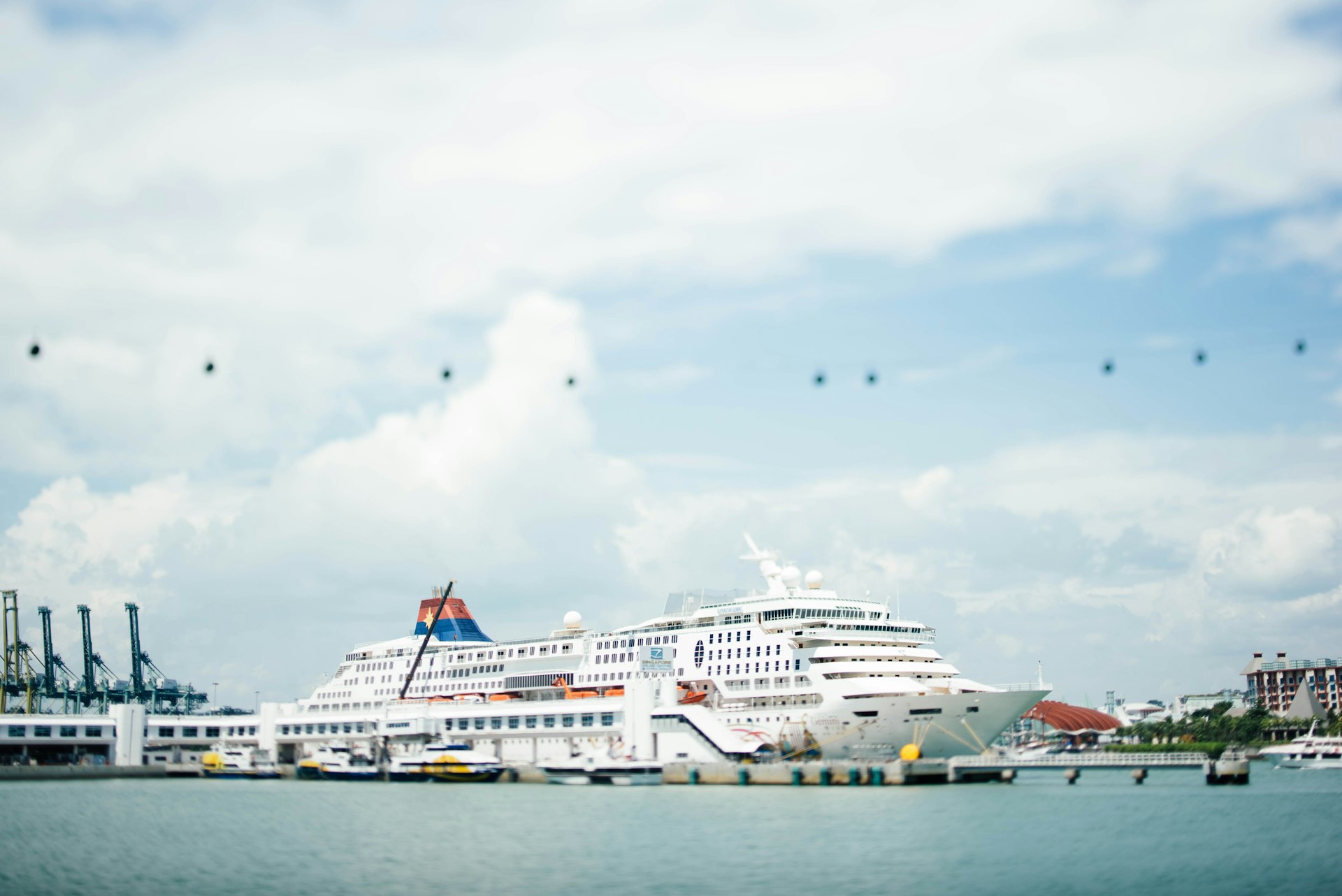 white cruise ship docking on blue bod of water under blue sky