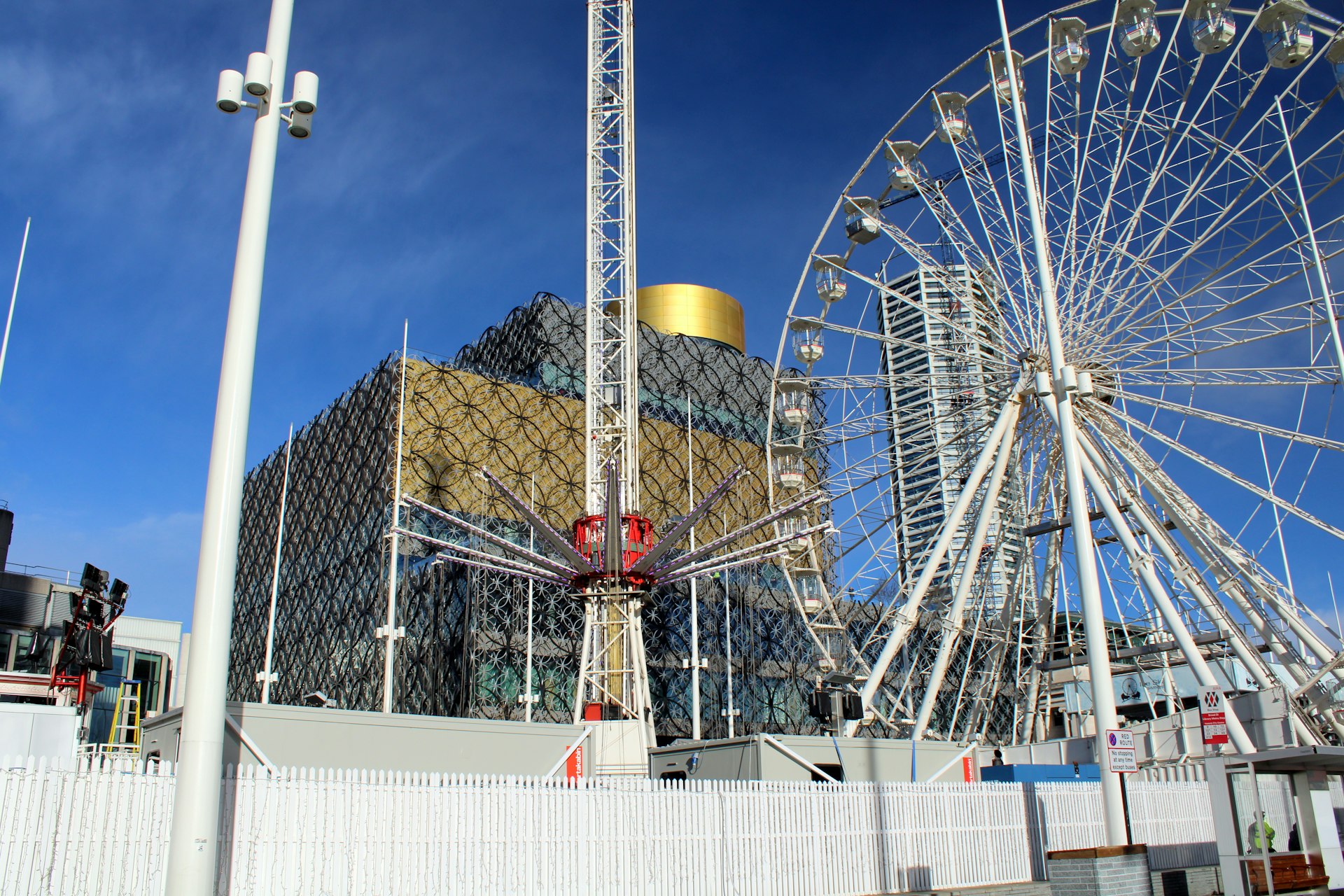 A large ferris wheel sitting next to a tall building