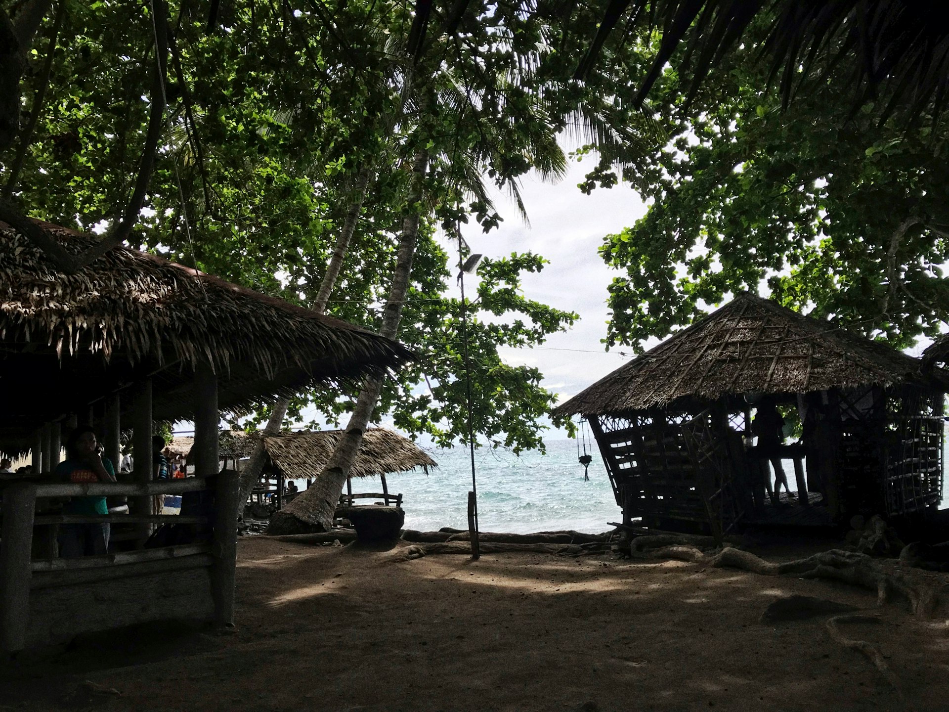 brown wooden house near green trees during daytime