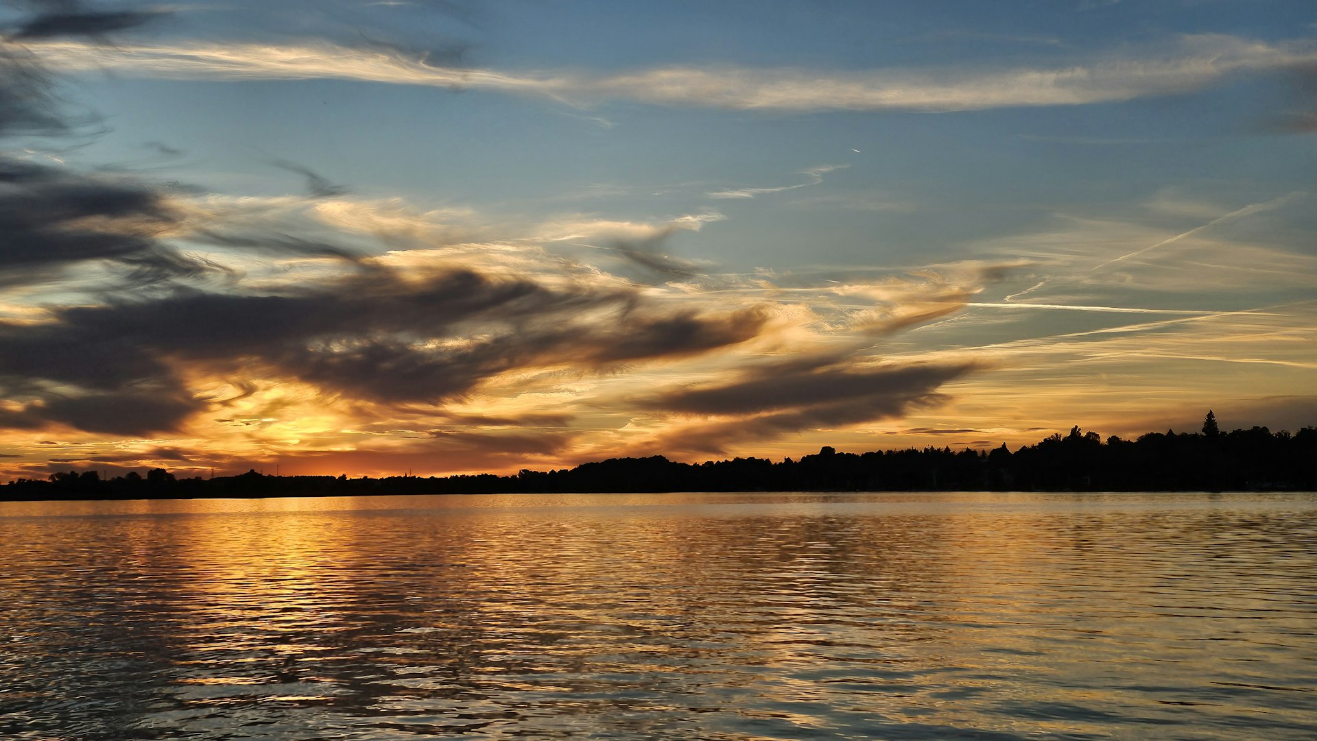 the sun is setting over a body of water