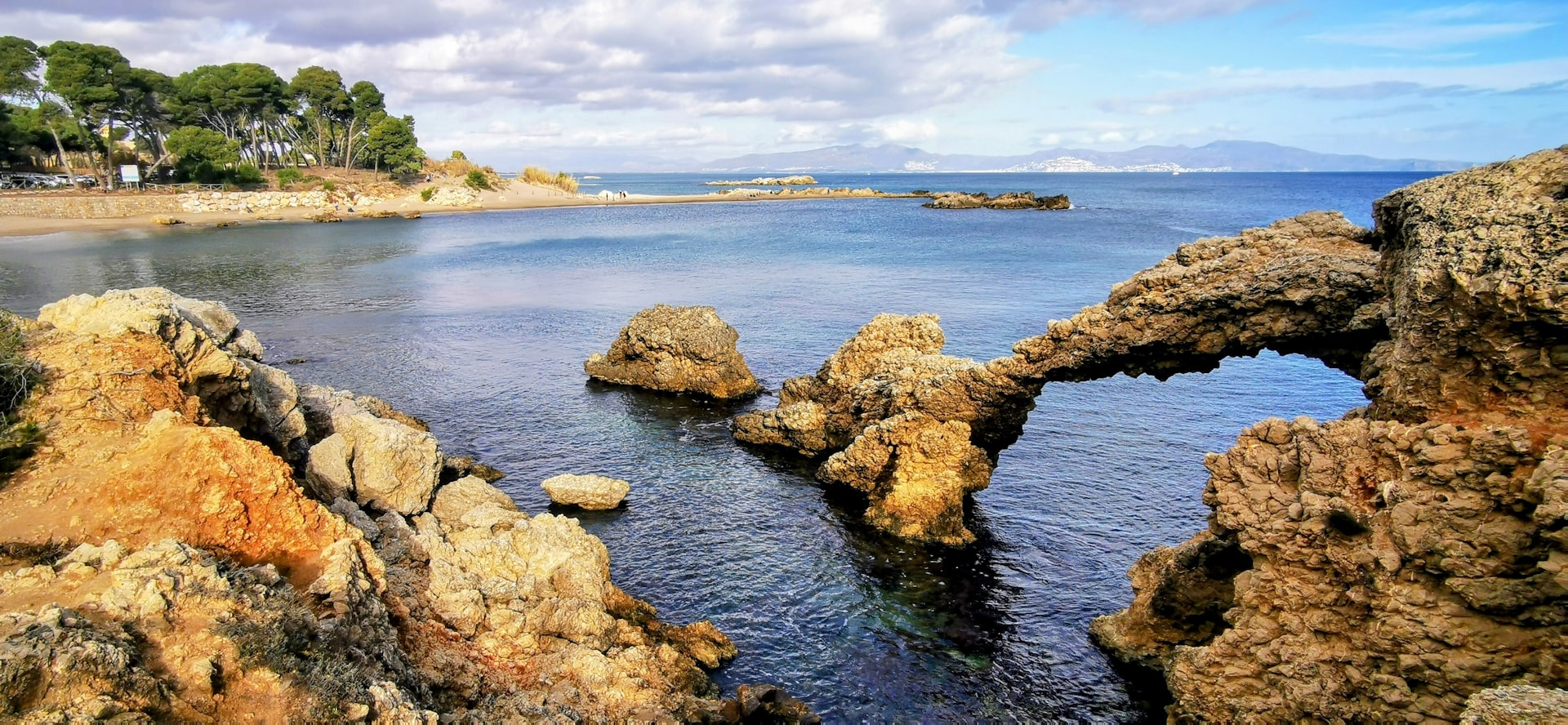 a body of water surrounded by rocks and trees