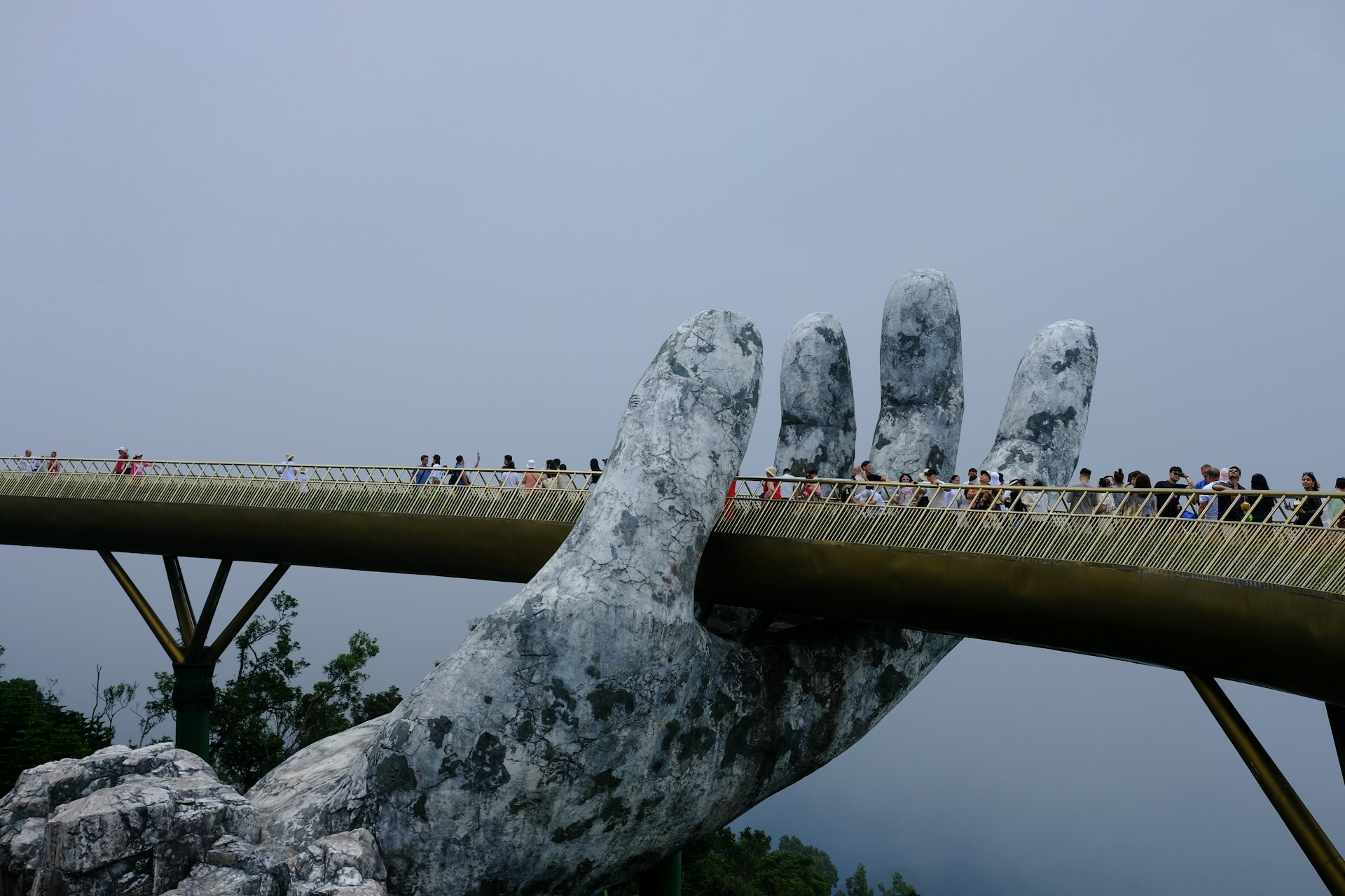 A very large hand that is on a bridge