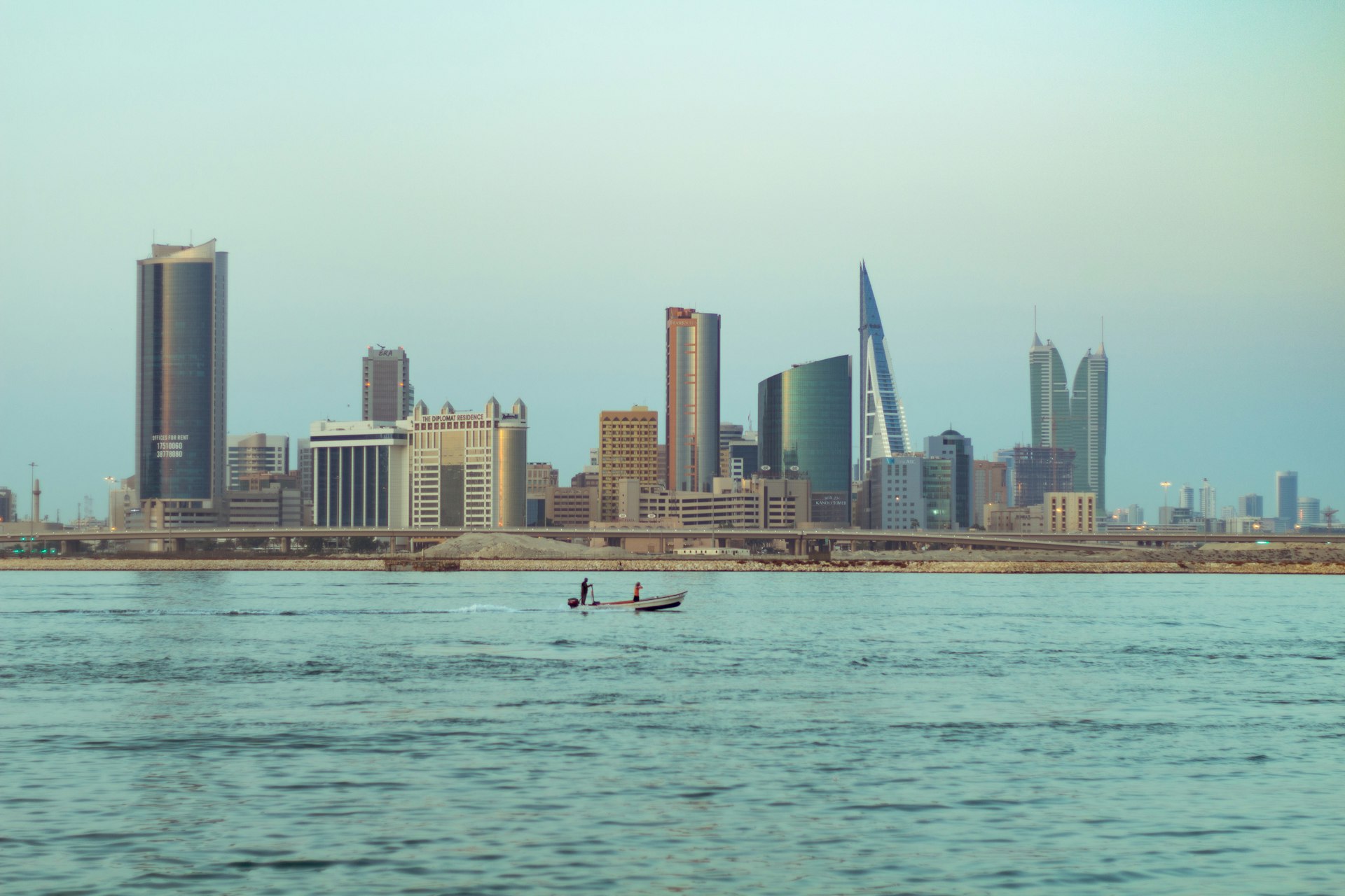 person riding on white boat on sea during daytime