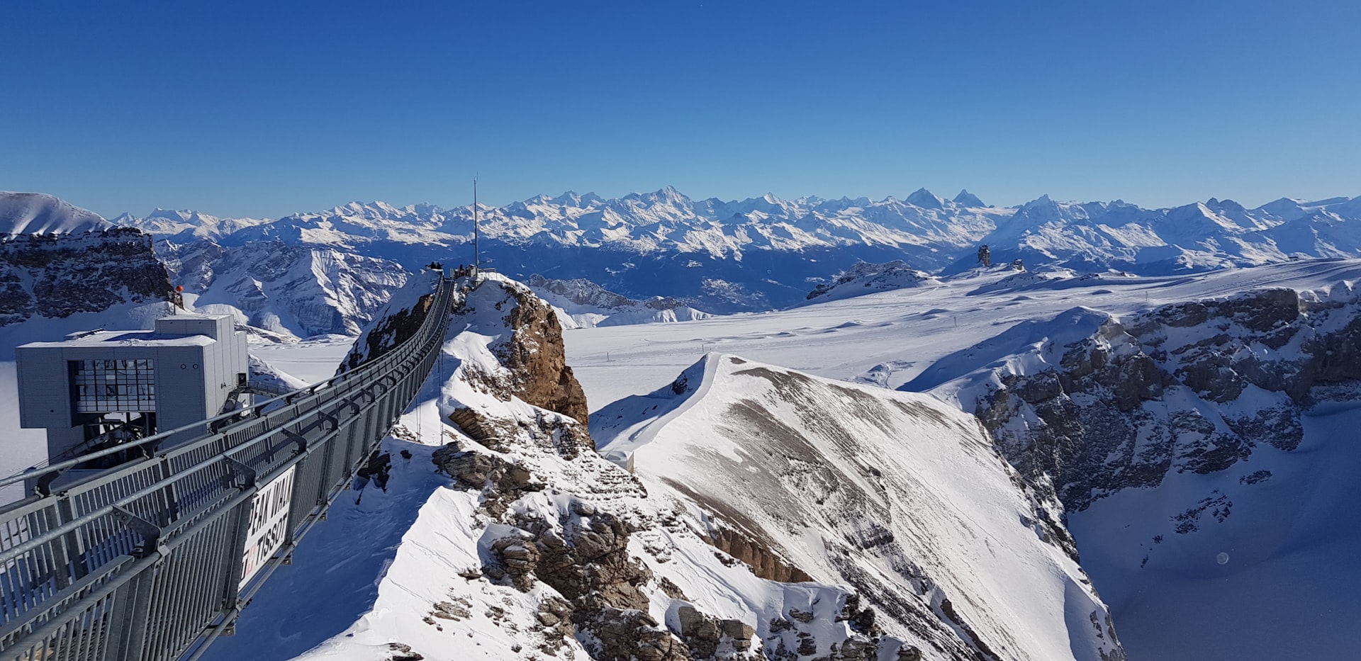 A snow covered mountain with a bridge going over it