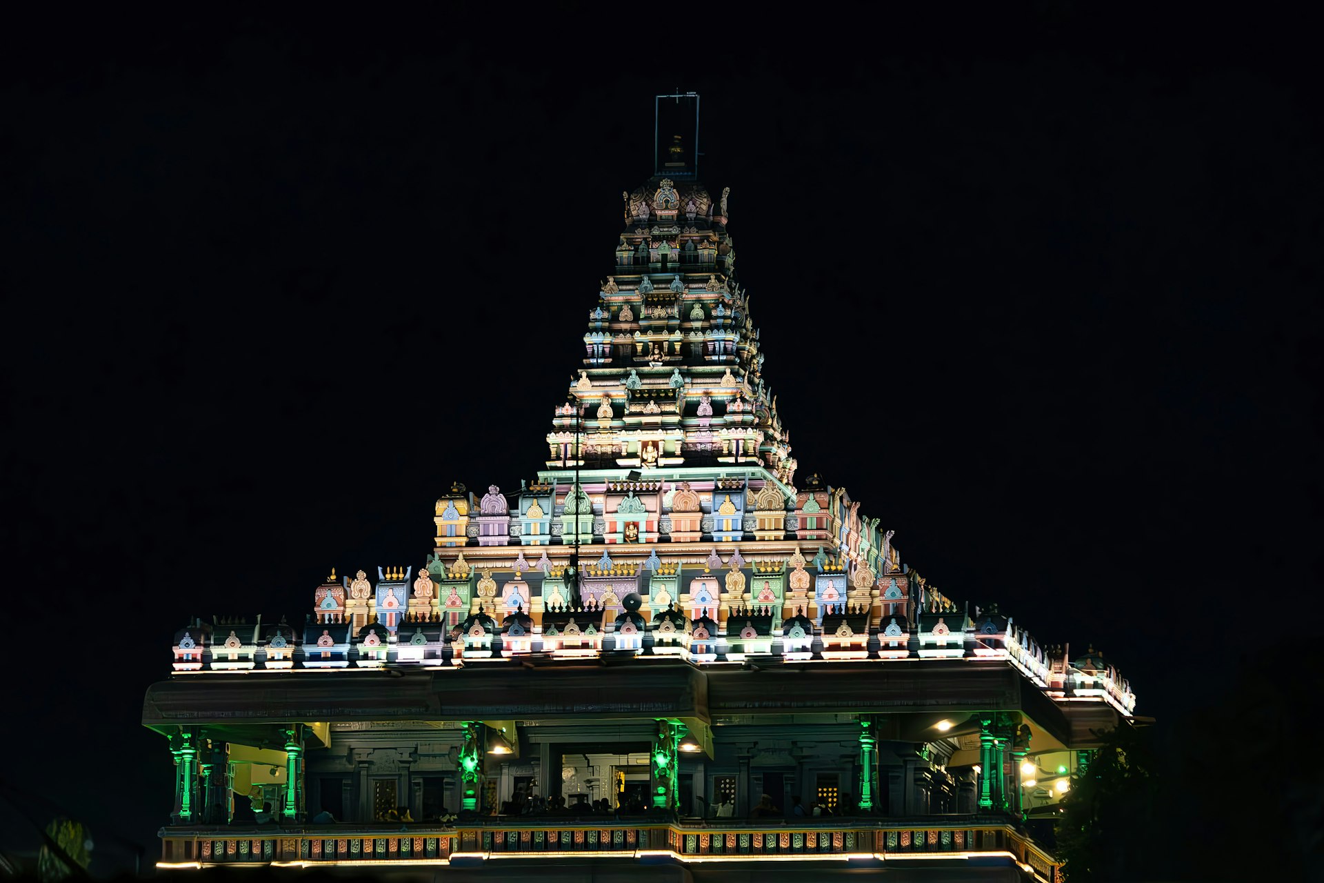 Illuminated temple glows against the night sky.