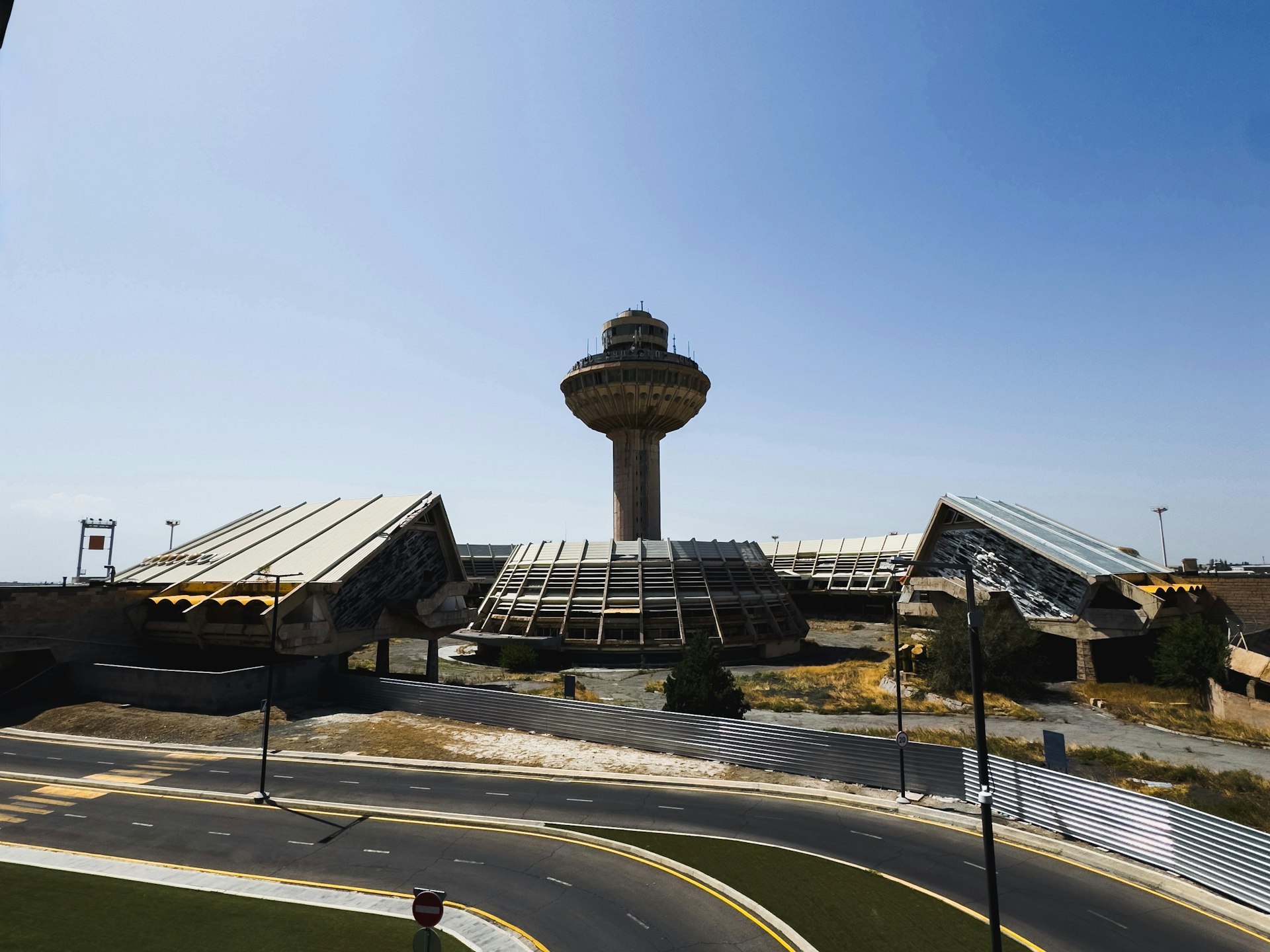 A view of an airport with a control tower in the background