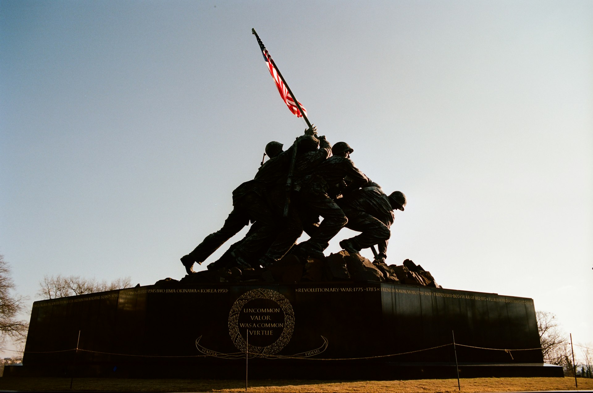 a group of soldiers standing on top of a monument