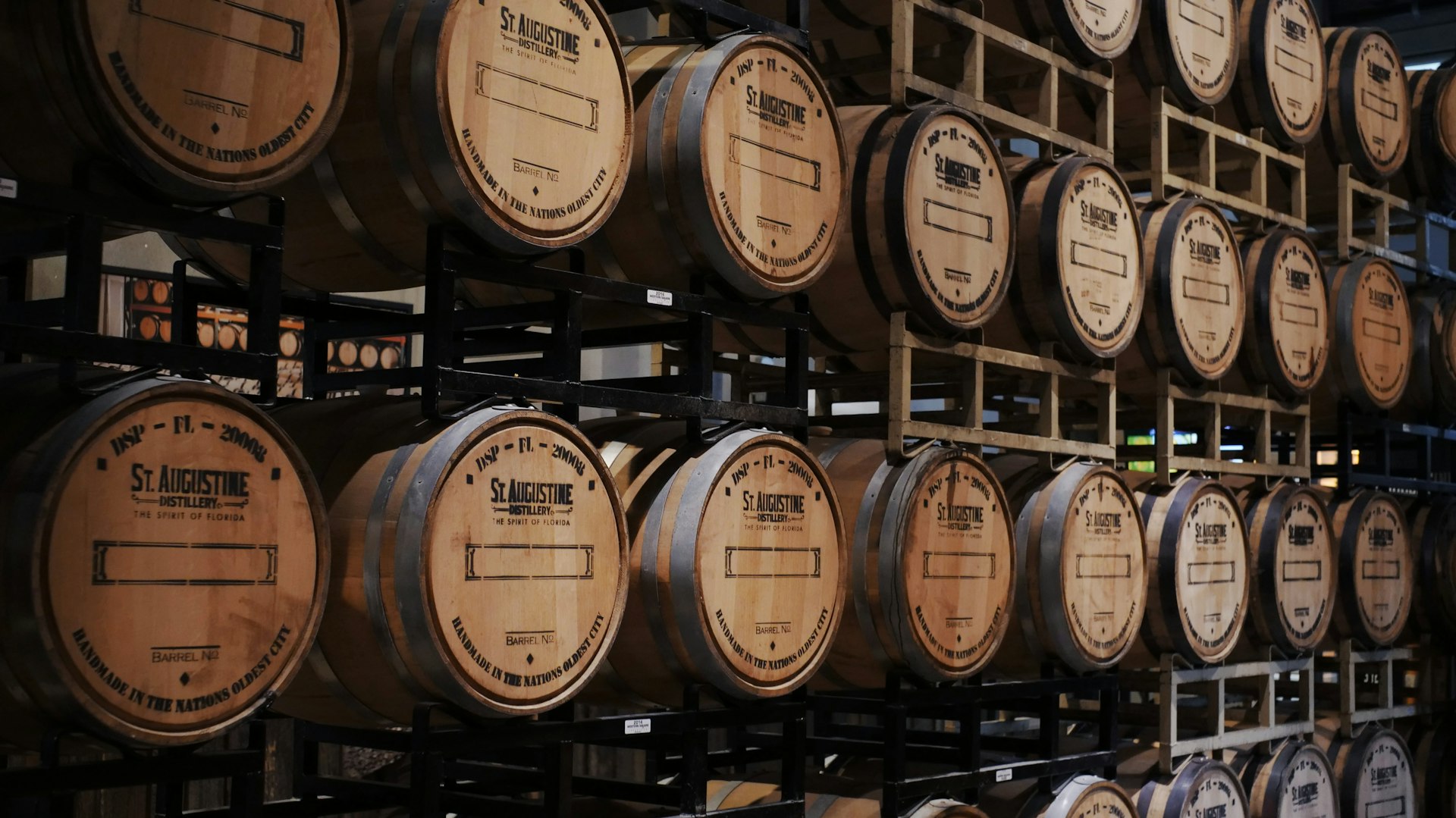 brown wooden barrels on rack