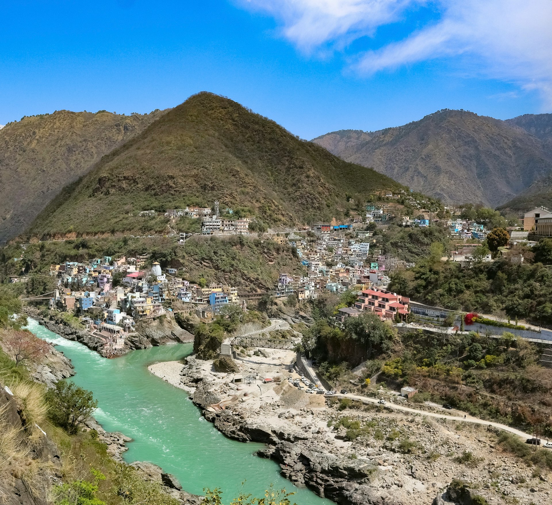 A town nestled beside a mountain and river.