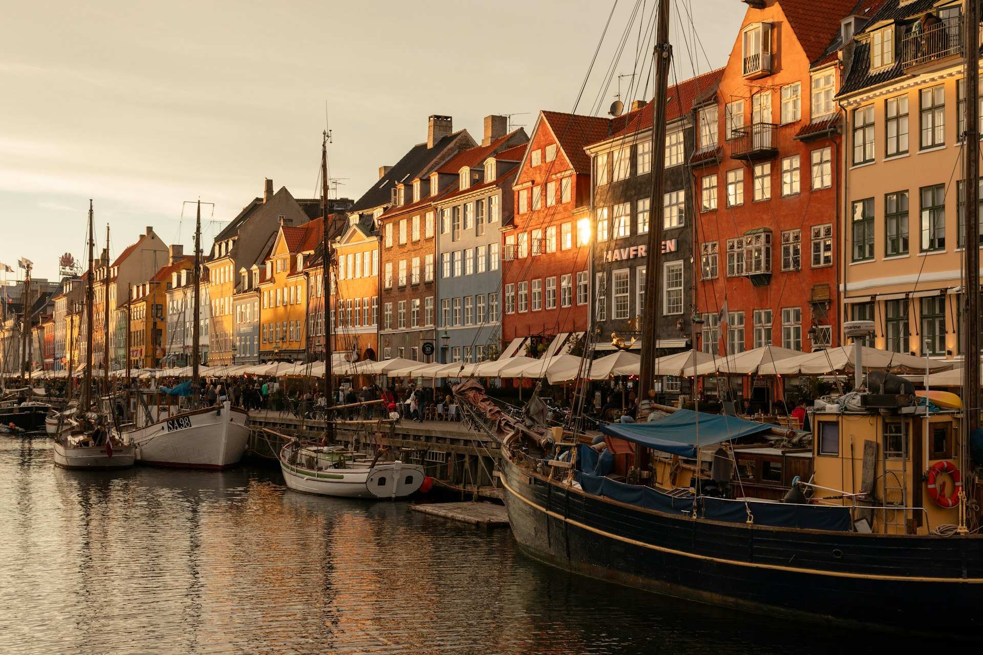 A harbor filled with lots of boats next to tall buildings