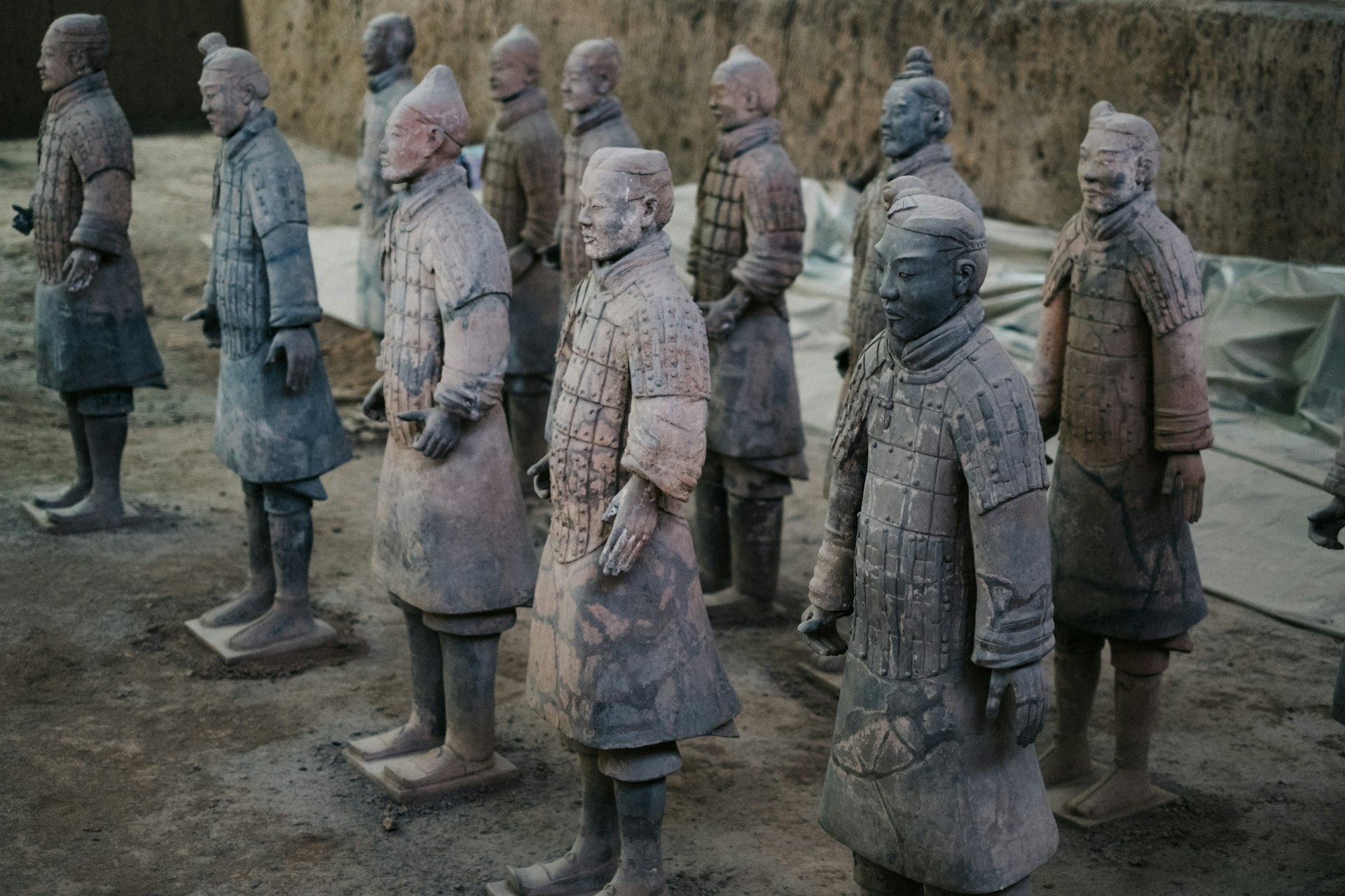 a group of statues of men standing next to each other