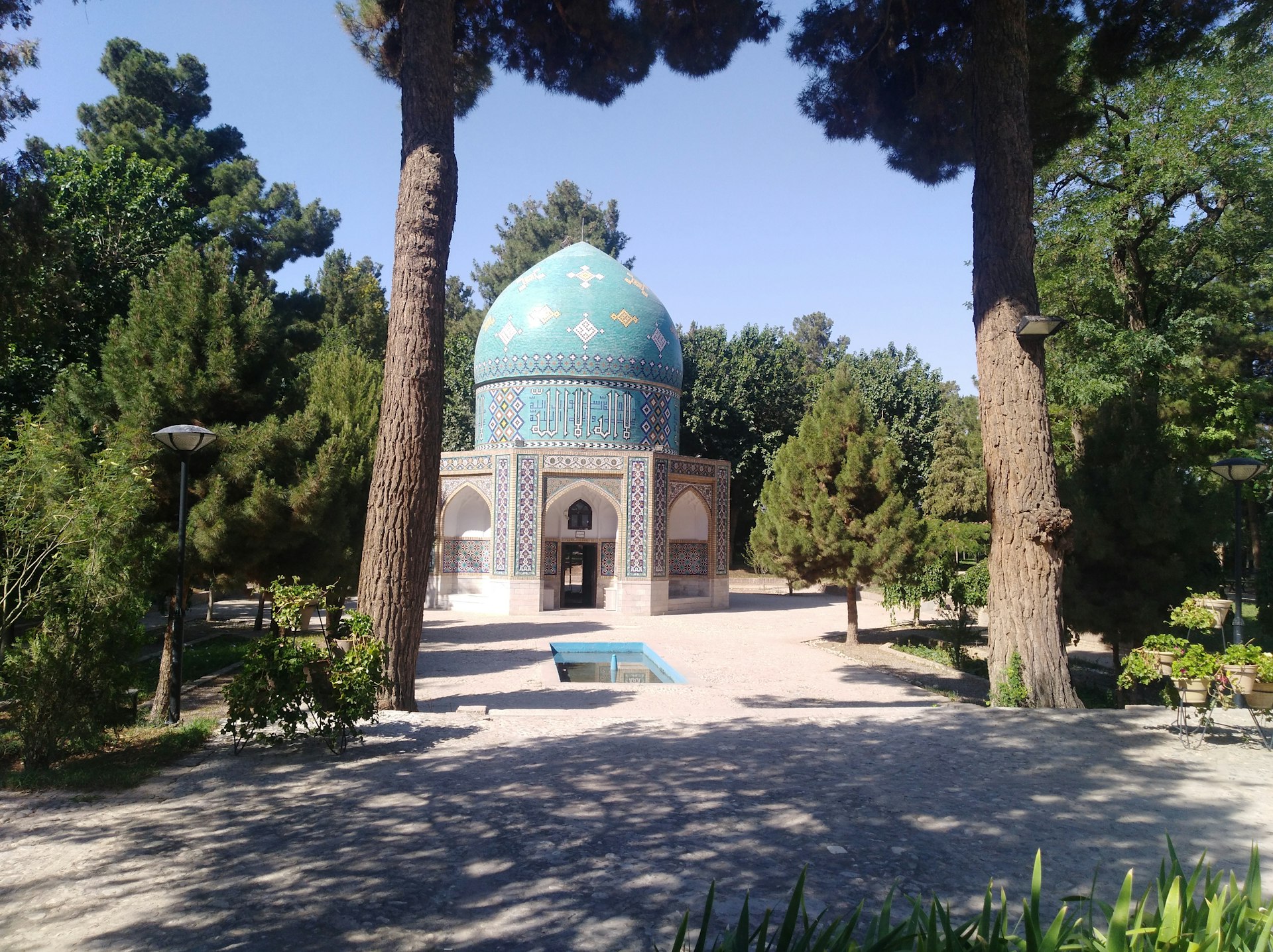 green and white dome building surrounded by trees