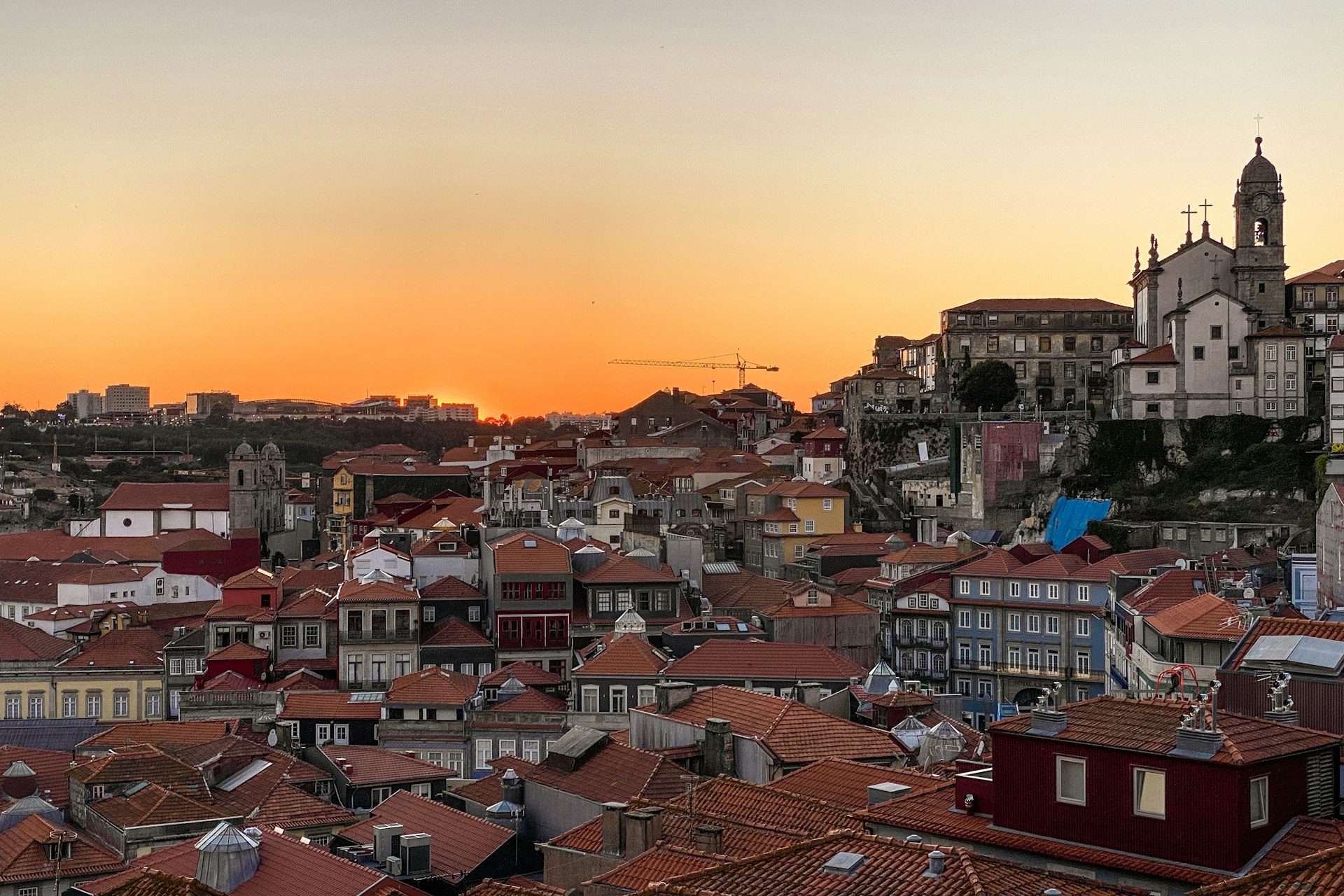 a sunset view of a city with many buildings