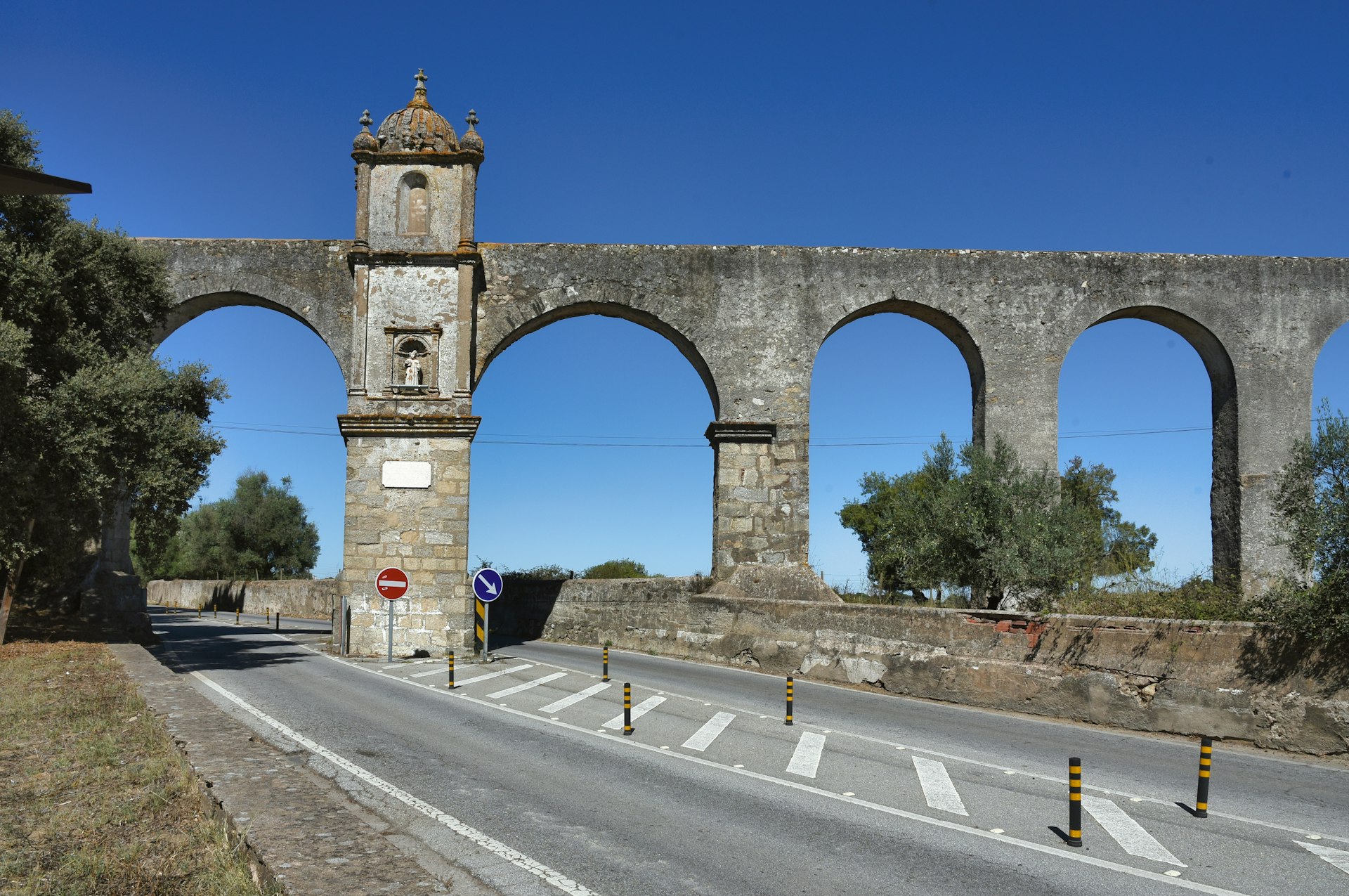 An old stone bridge with arches and a clock tower