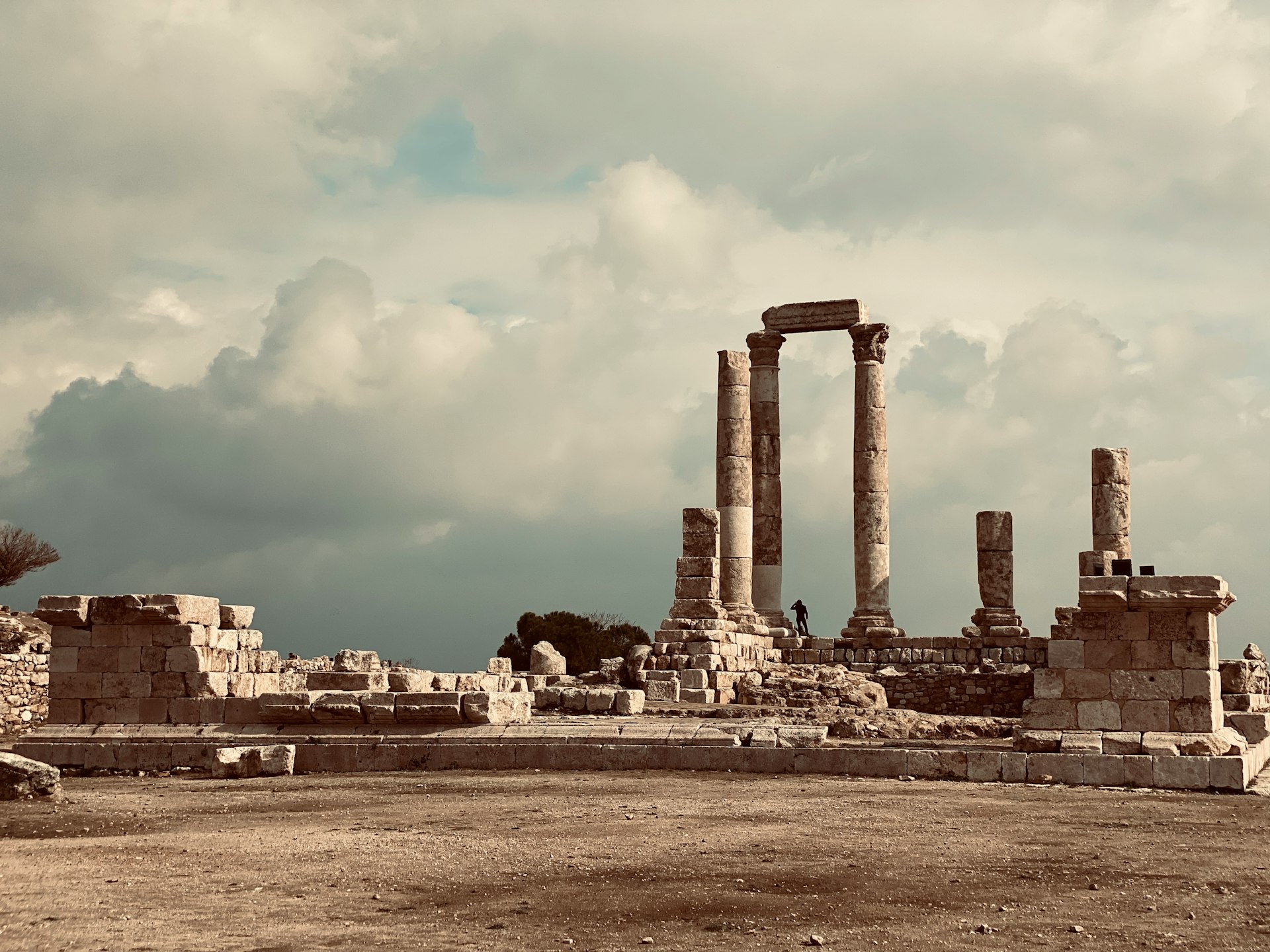 brown concrete building under white clouds during daytime