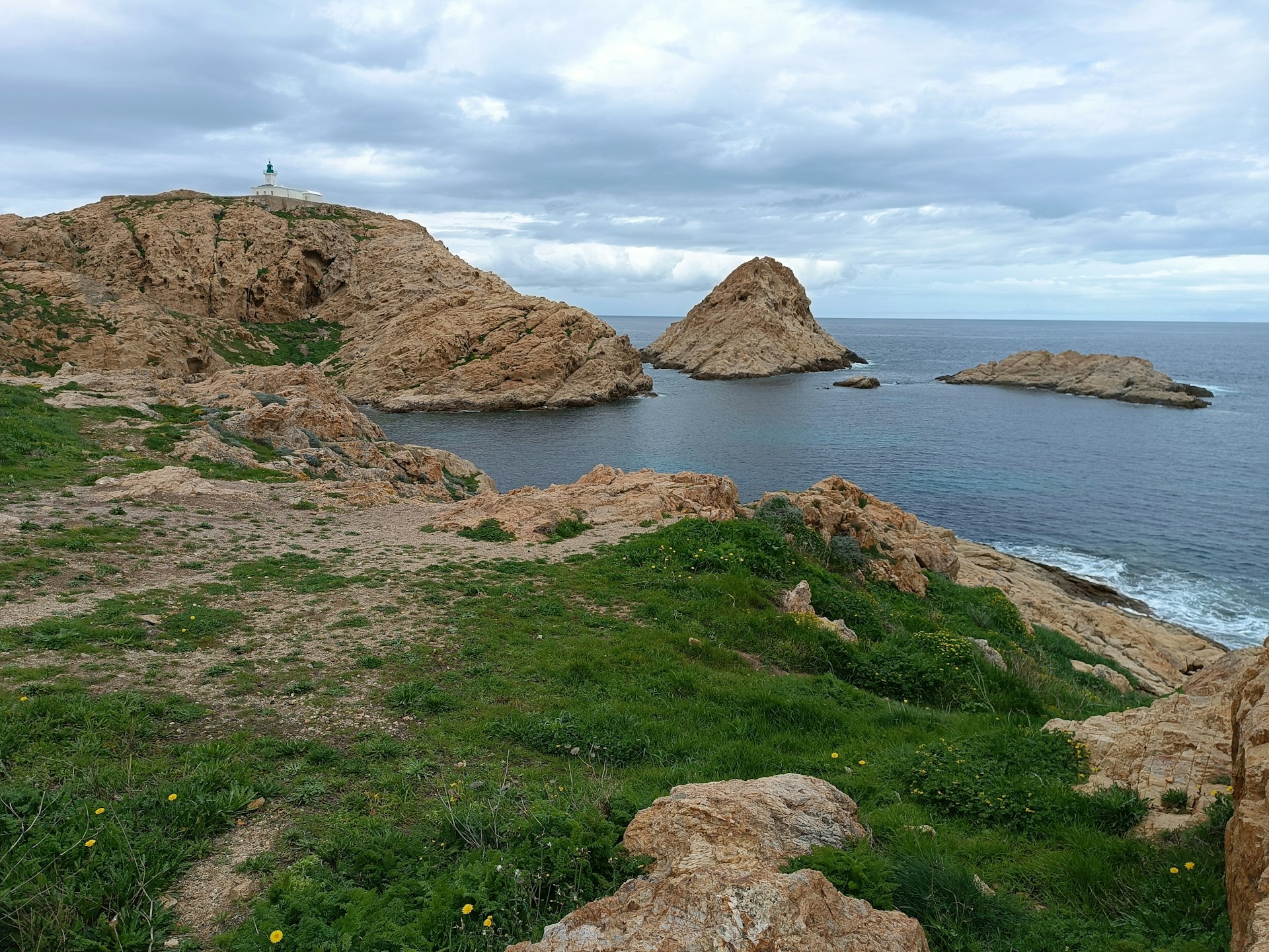 Rocky coastline with small islands on a cloudy day.