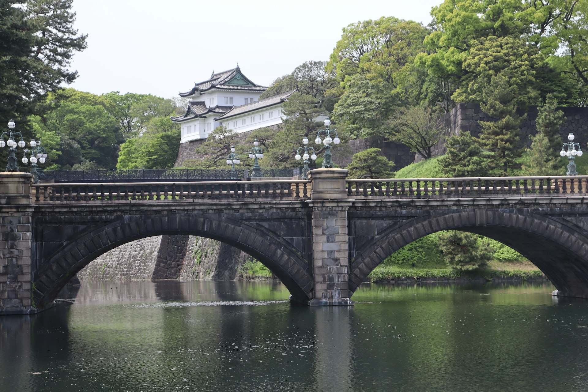 a bridge over a body of water with a castle in the background