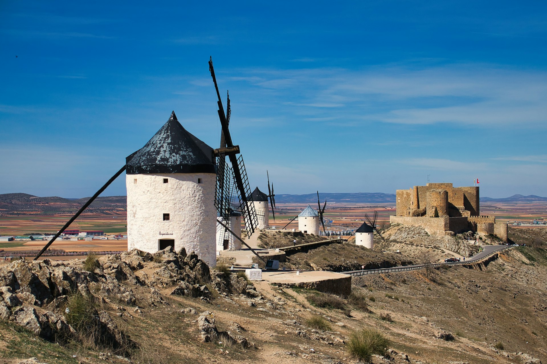 a windmill on top of a hill in the desert