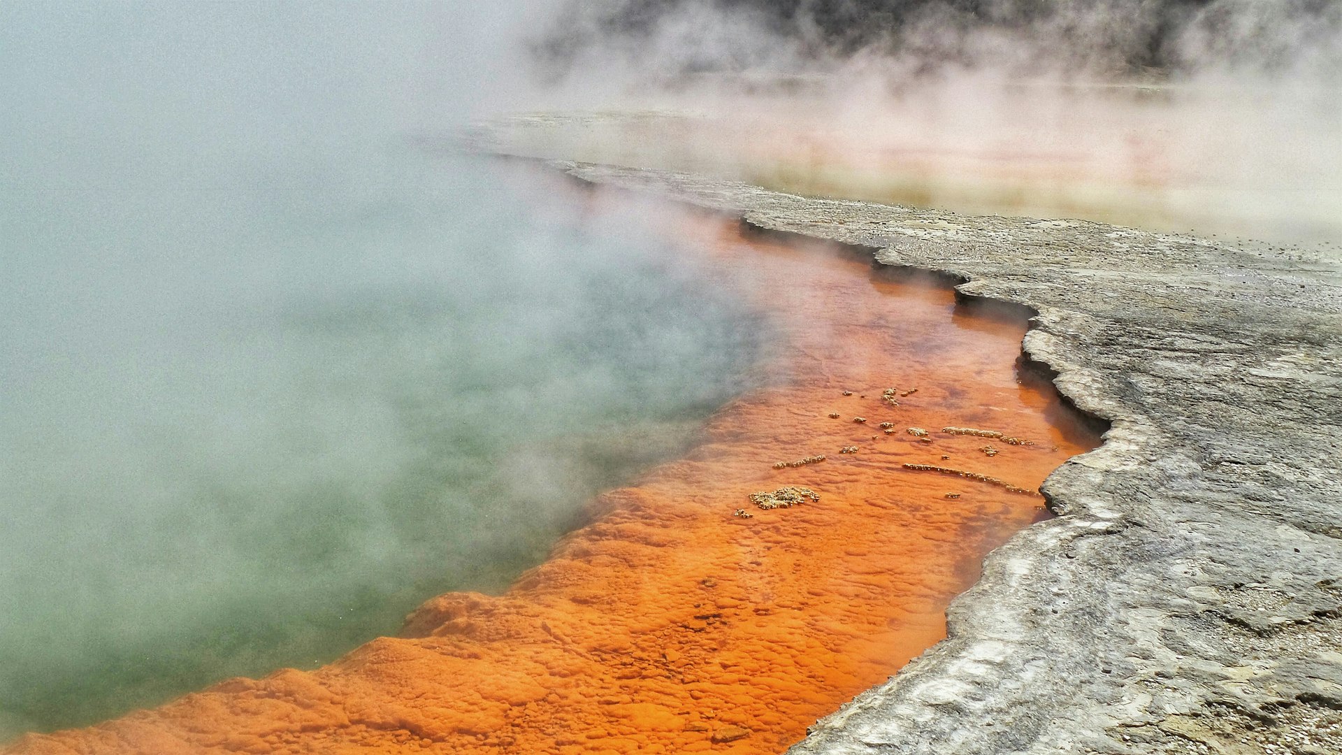 a body of water with steam rising from it