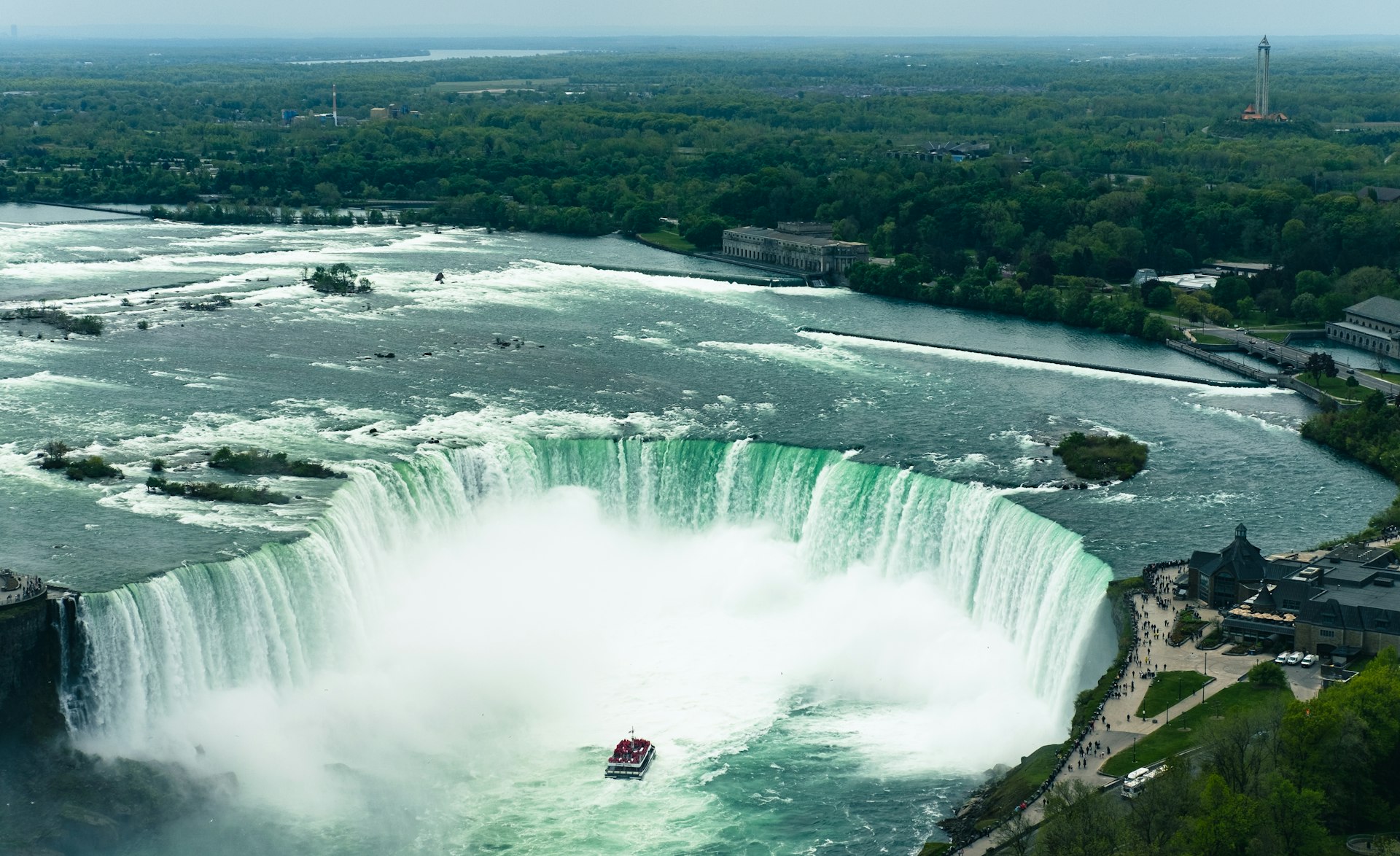 a boat is in the water near a waterfall