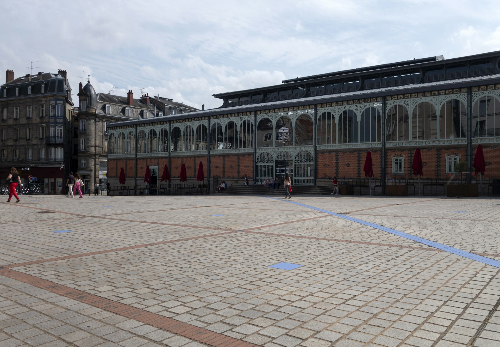 a group of people walking around a large building