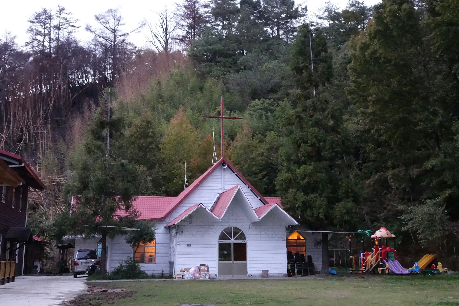 a small white church with a cross on top of it
