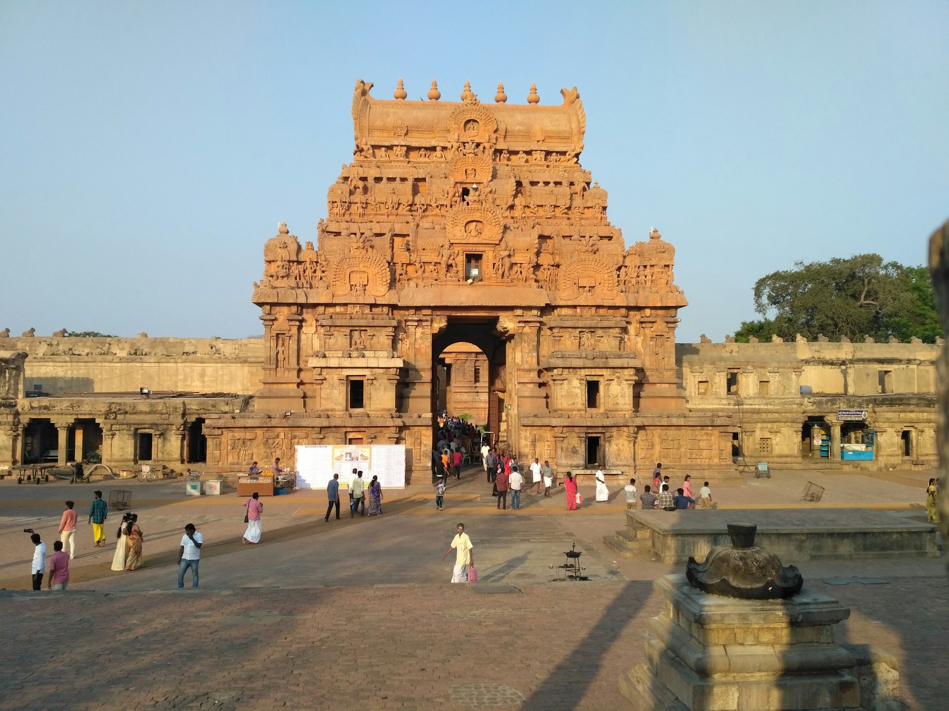 people gathered outside brown concrete building