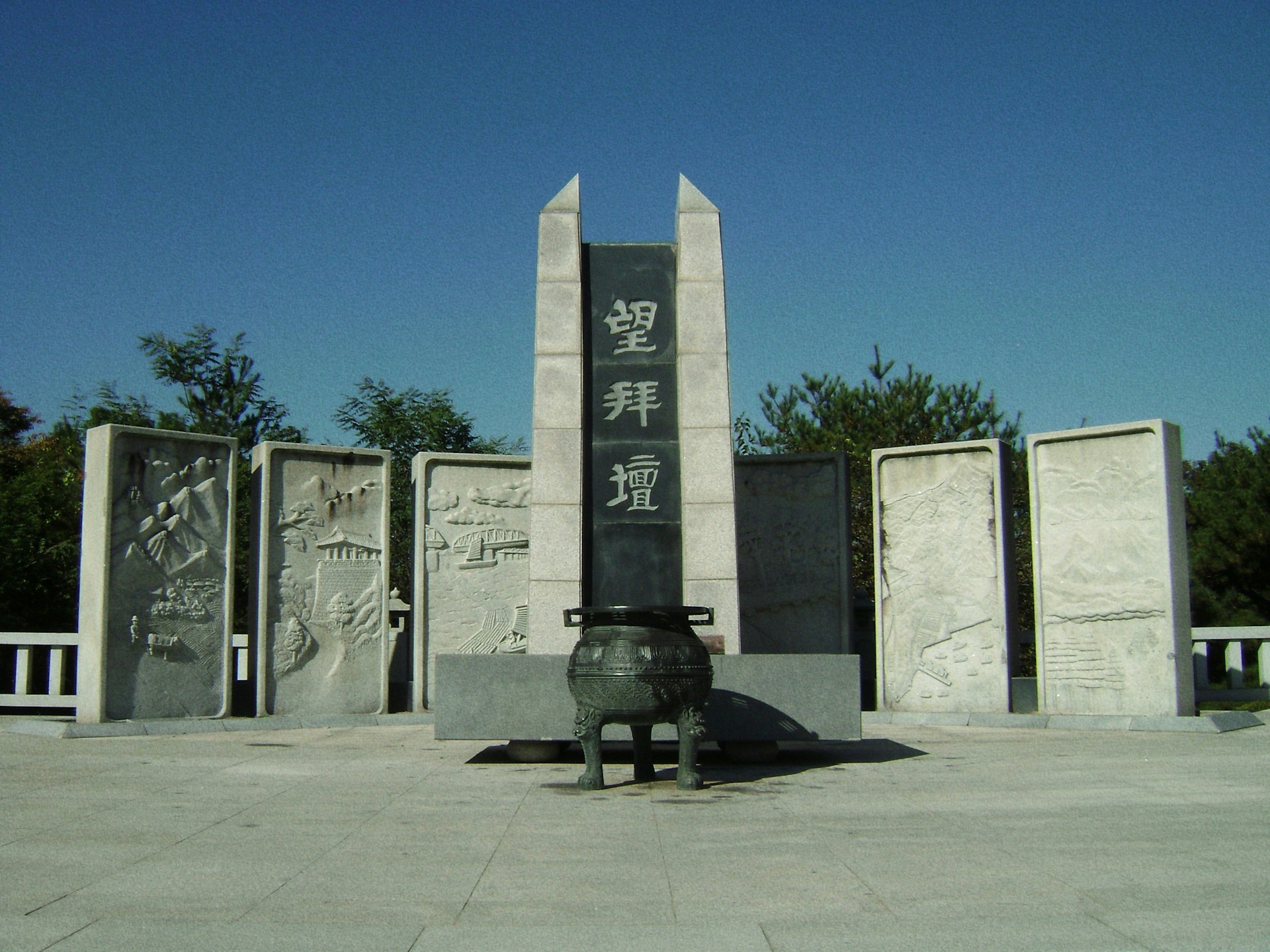 a statue of a dog in front of a monument