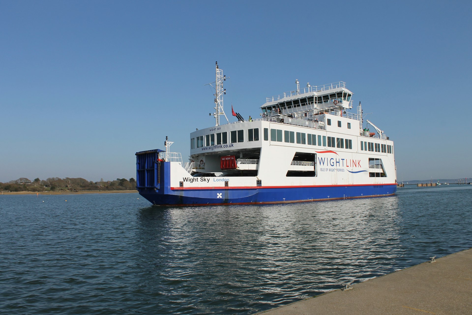 a large white and blue boat floating on top of a body of water