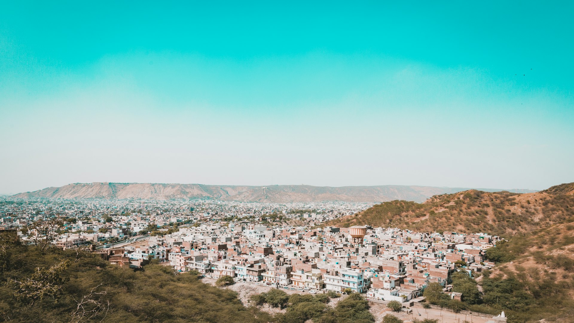 a view of a city with mountains in the background
