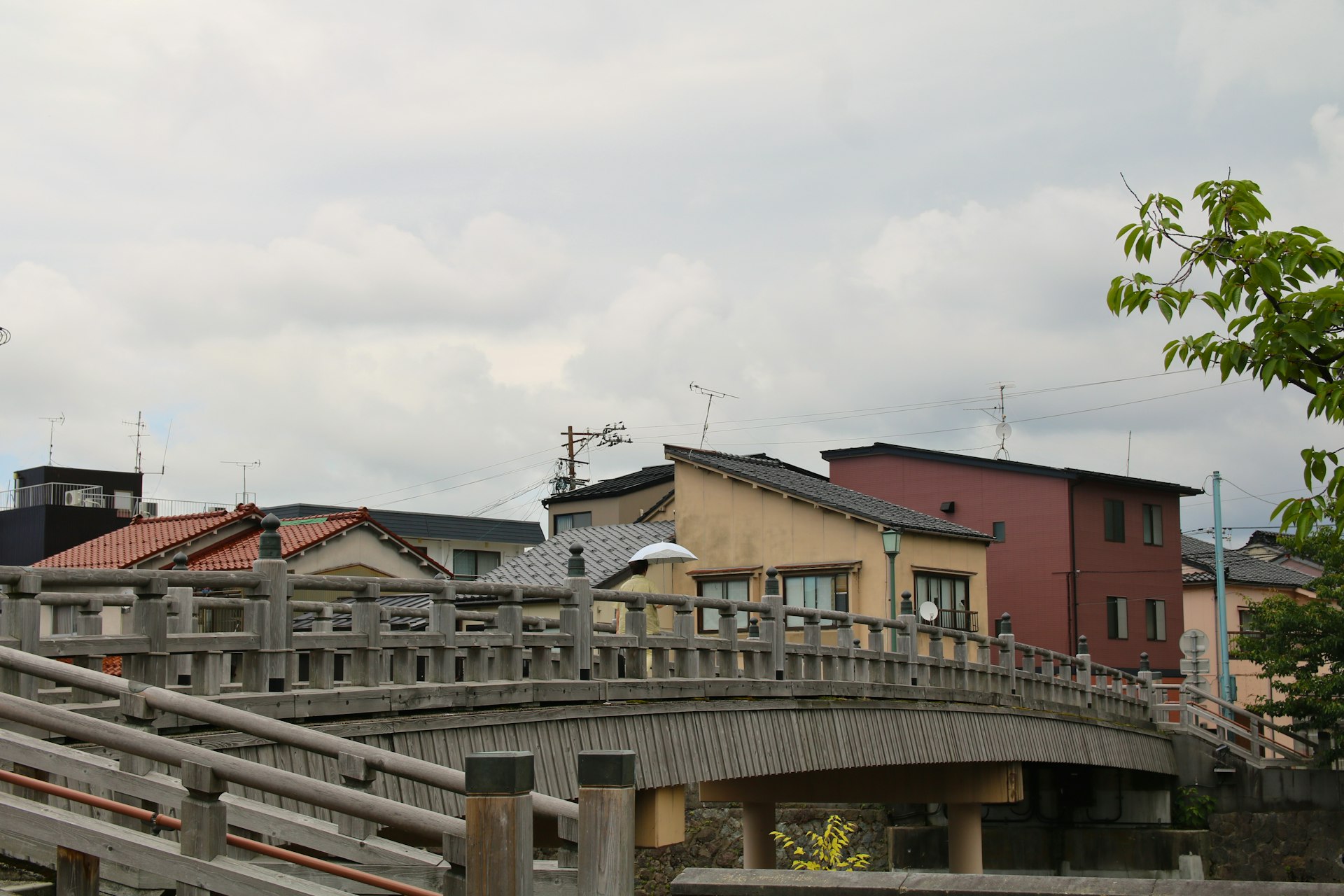 A bridge over a body of water with buildings in the background