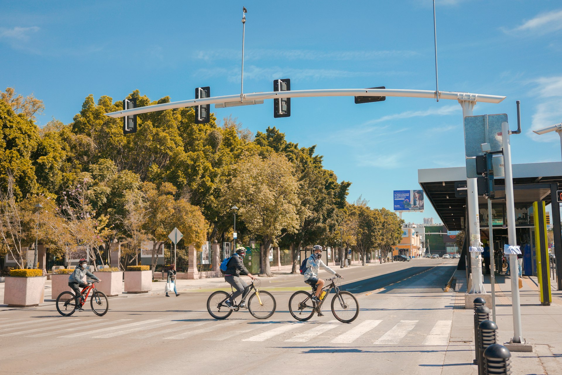 a group of people riding bikes across a street