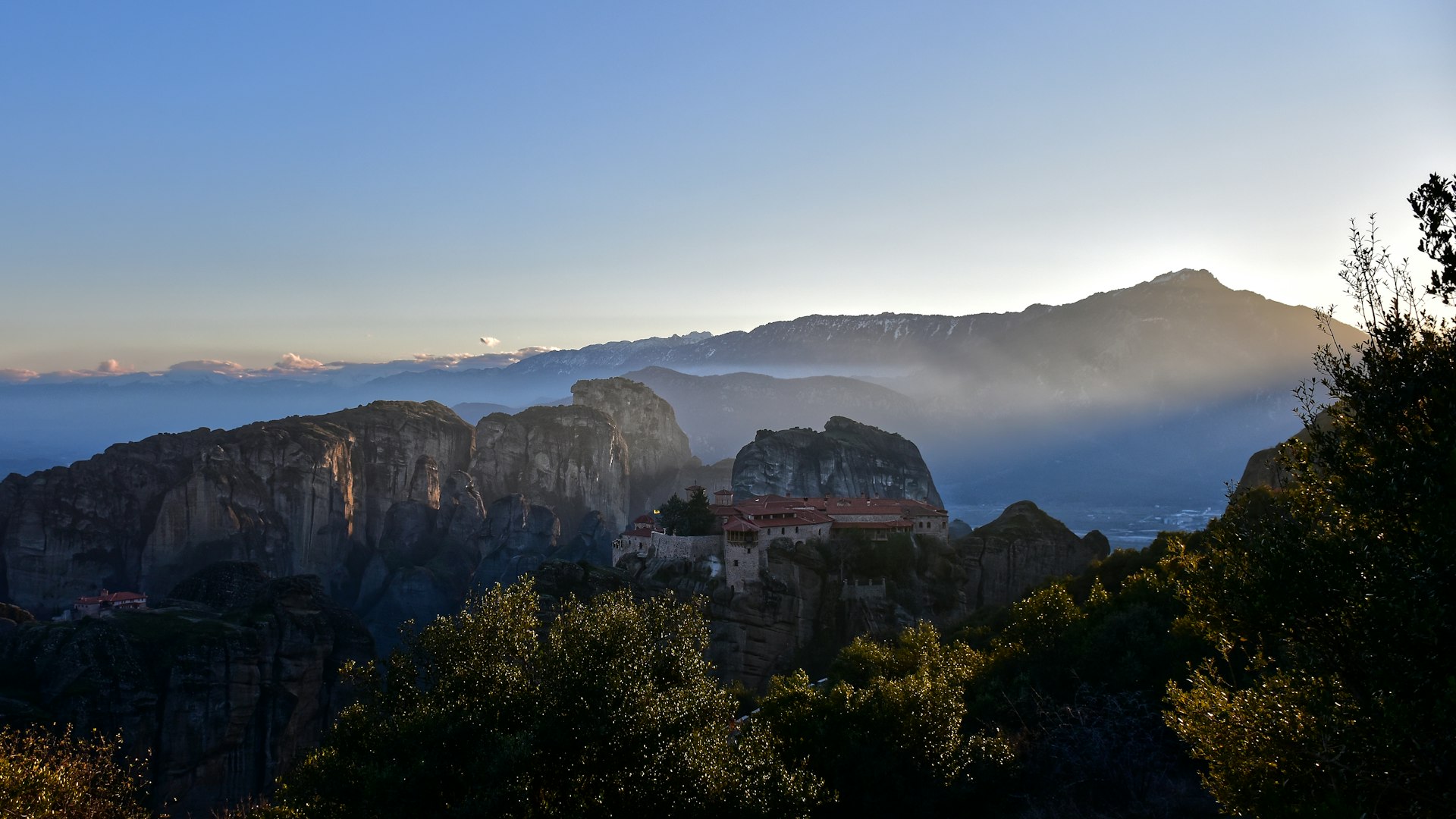 The sun shines on the mountains in the distance
