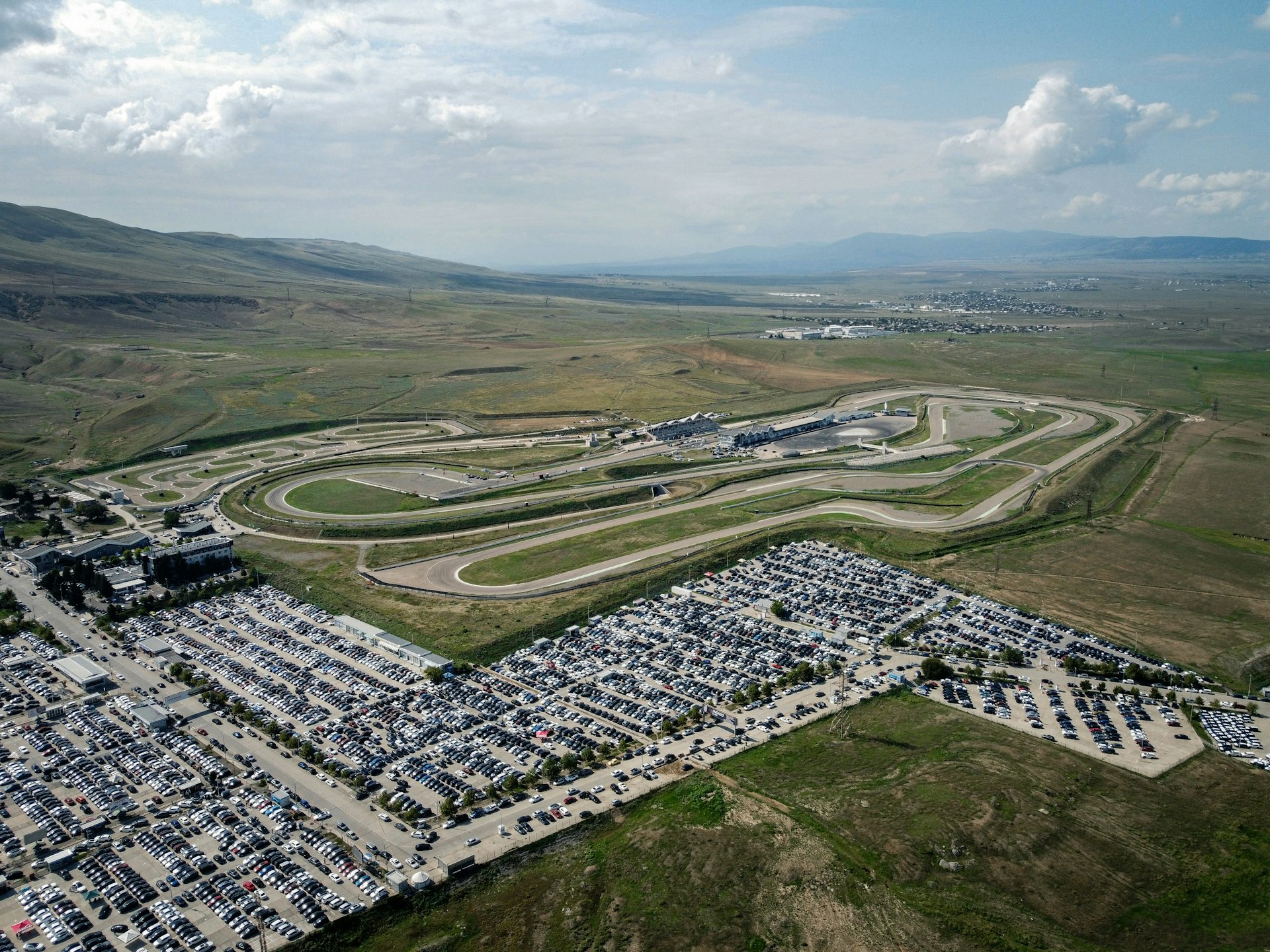 An aerial view of a parking lot and a race track